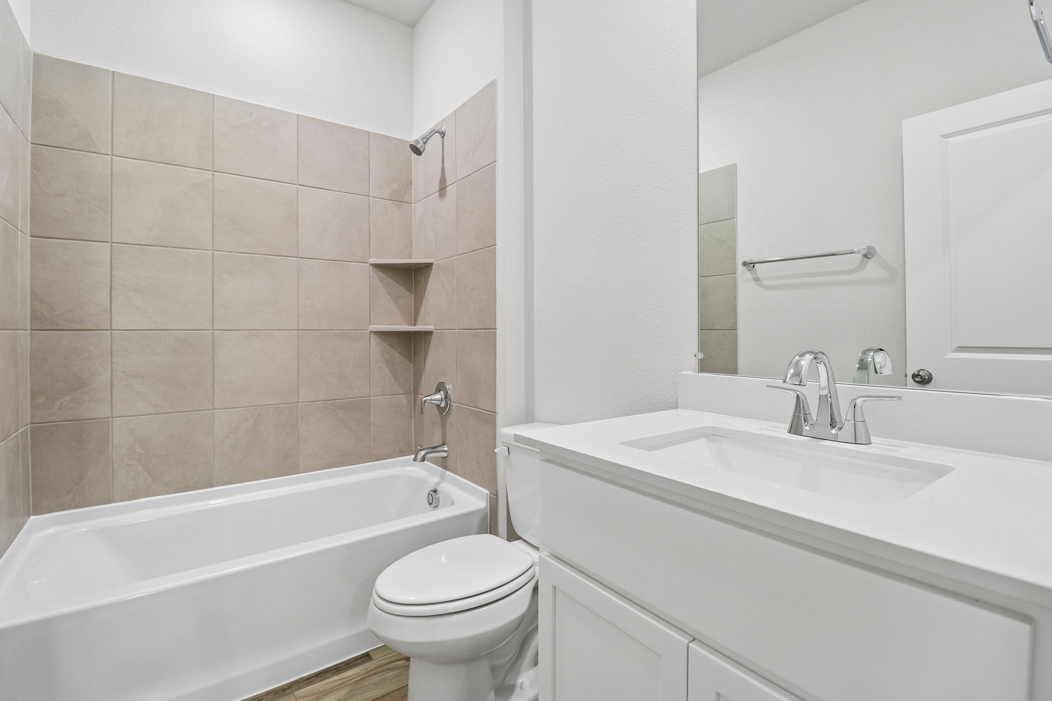 A bathroom with a tub sink and toilet.