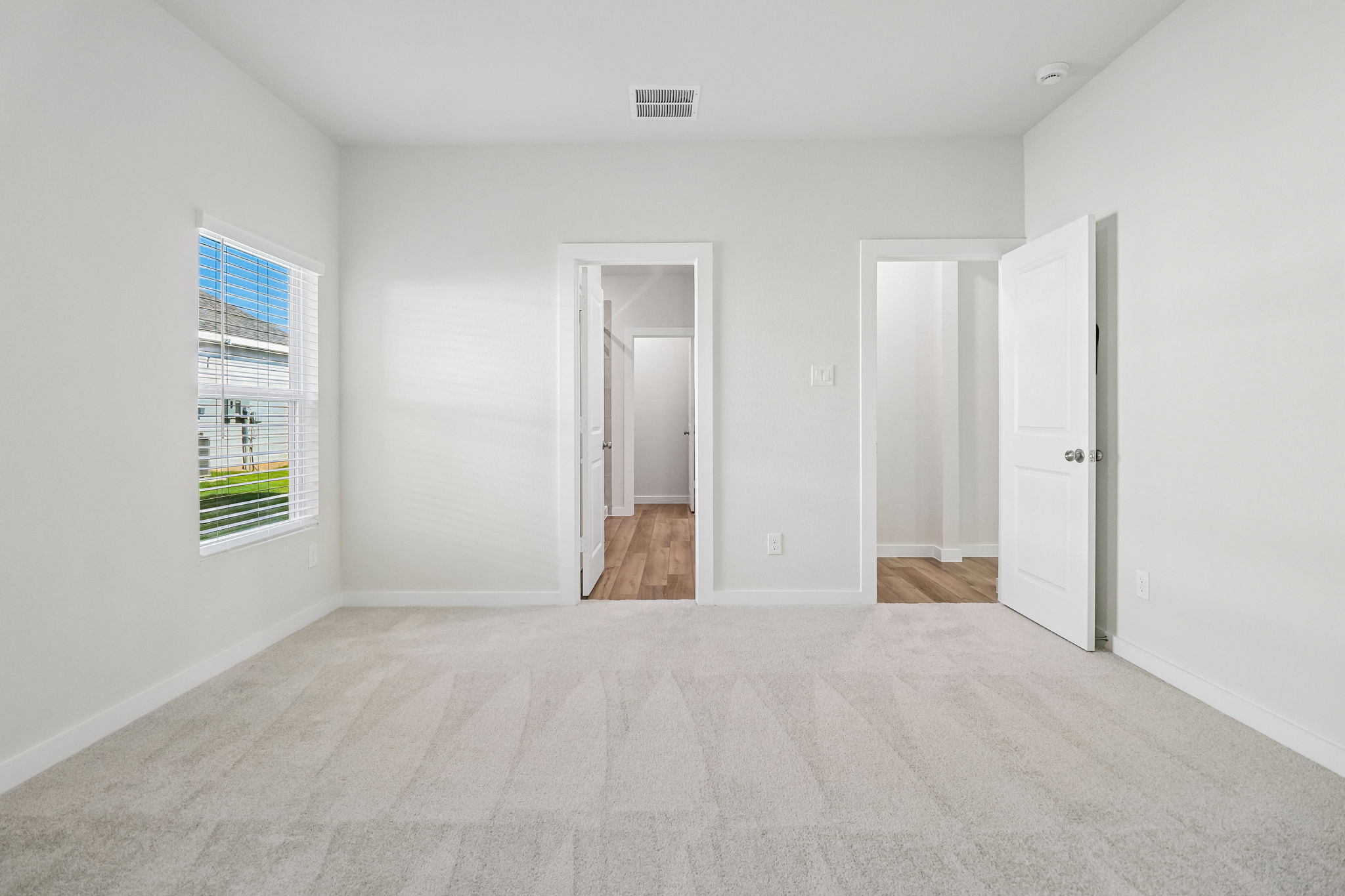 A hallway with white walls.