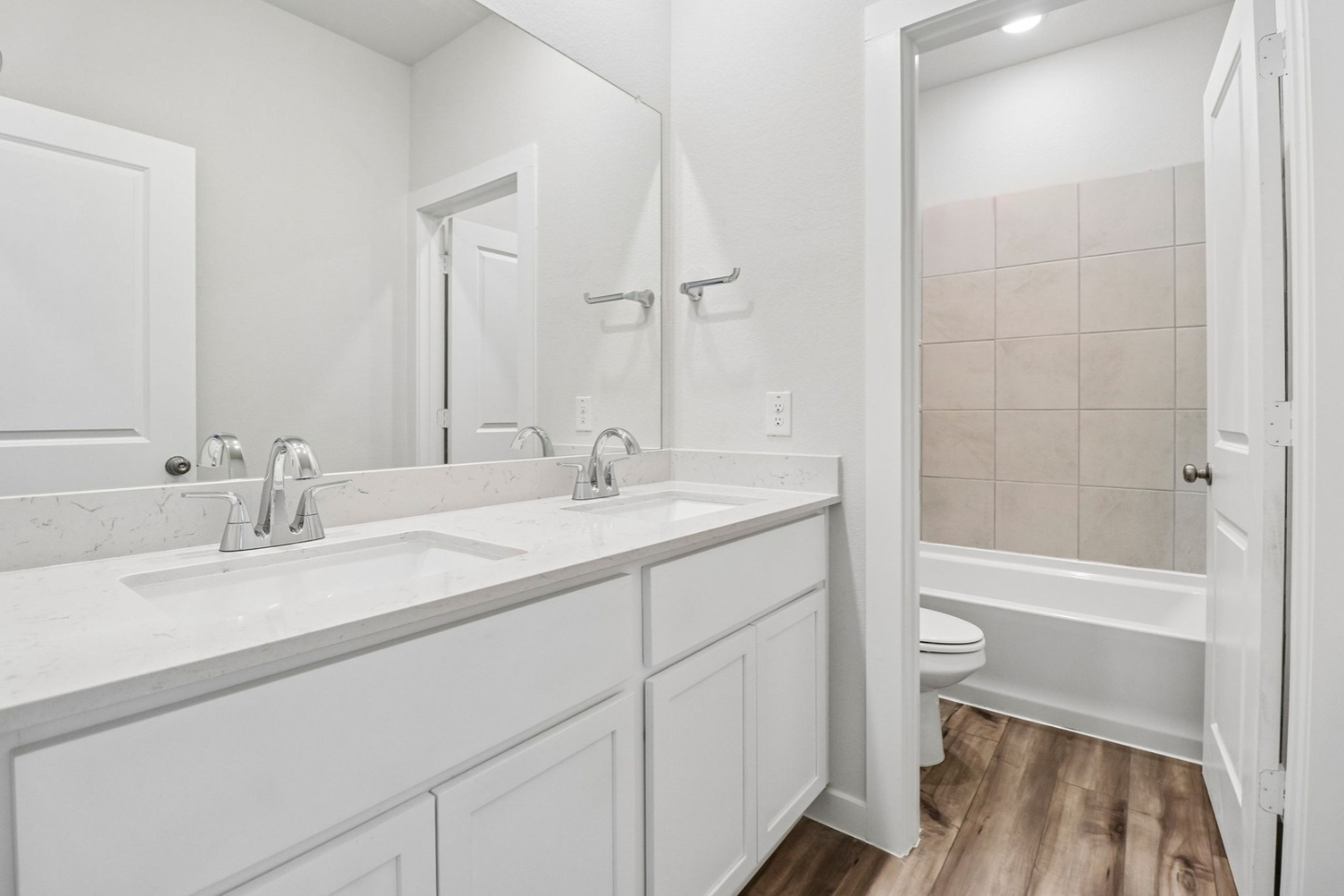 A bathroom with a tub sink and toilet.