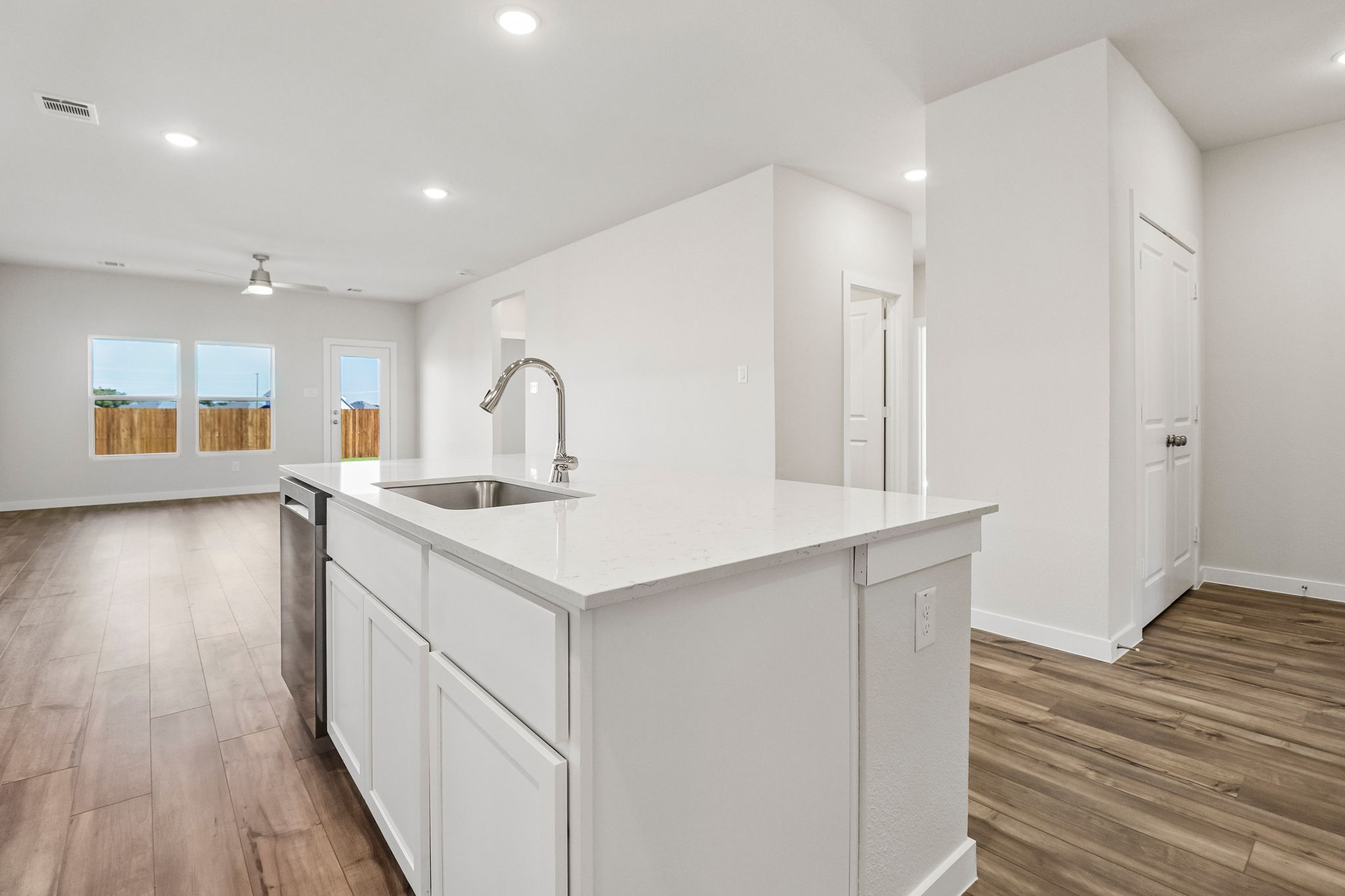 A kitchen with white cabinets.