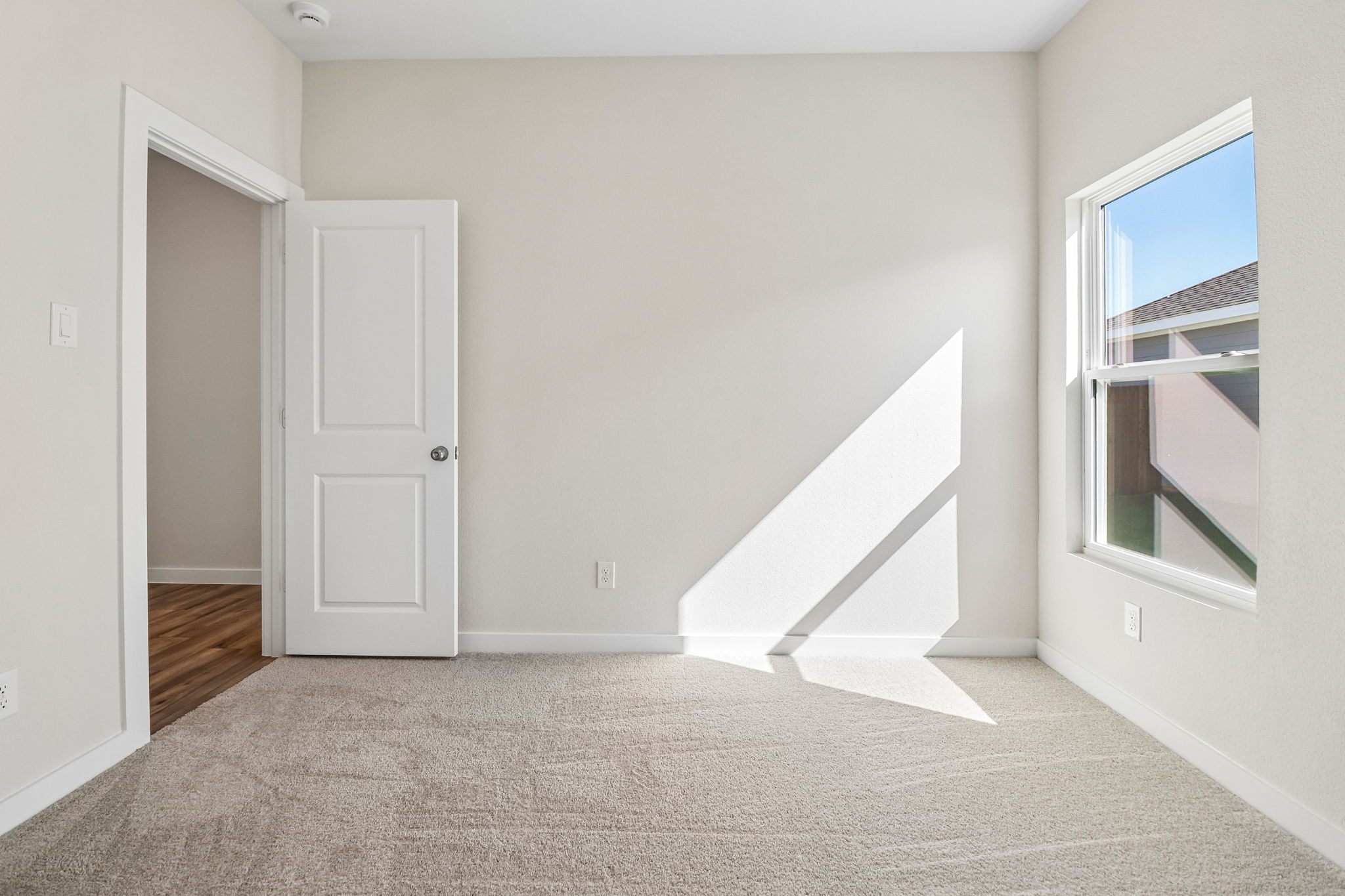 A room with white walls and a staircase.