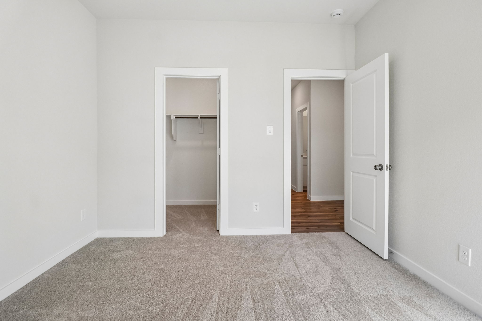 A hallway with white doors.