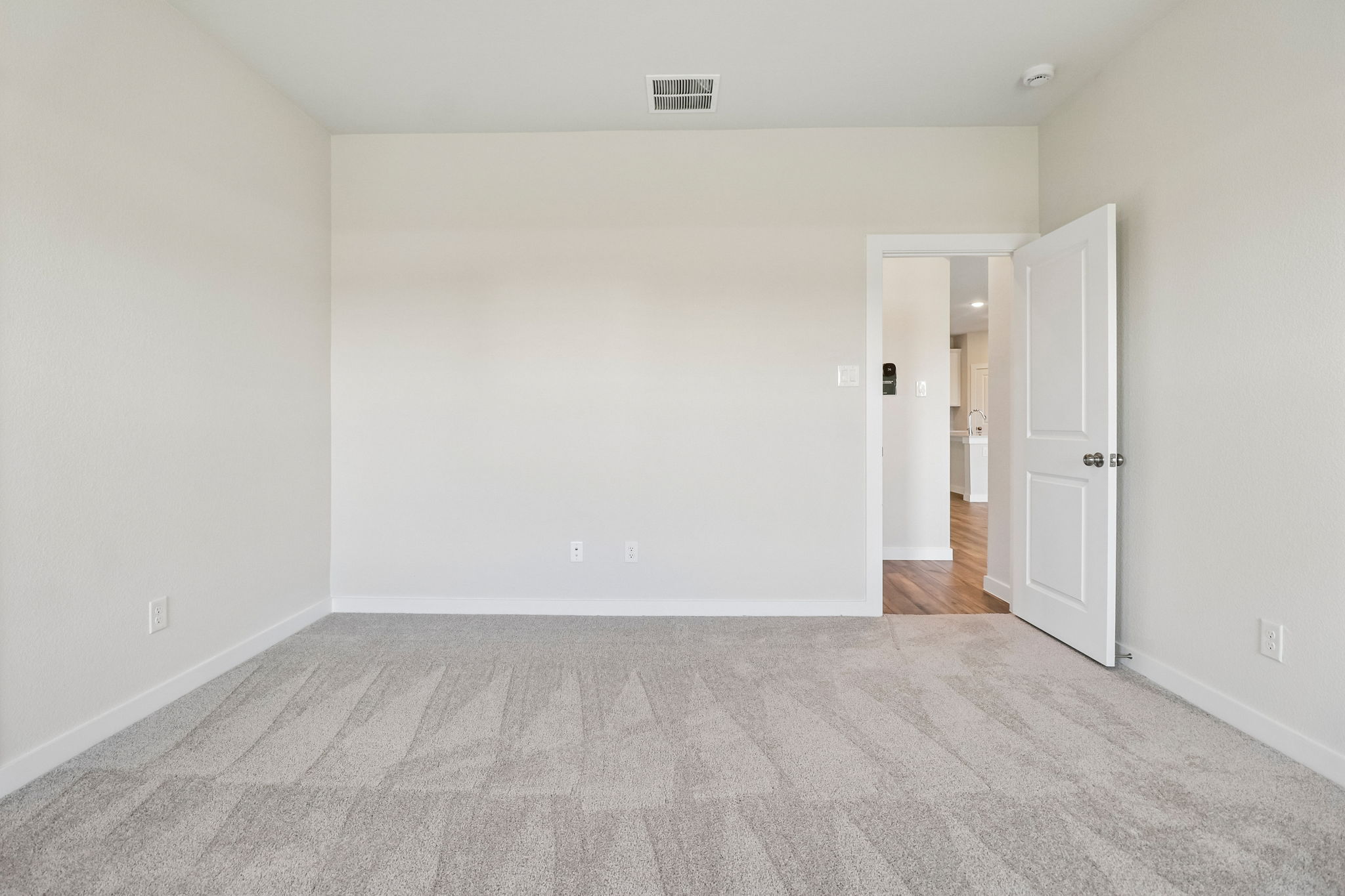 A hallway with white doors.