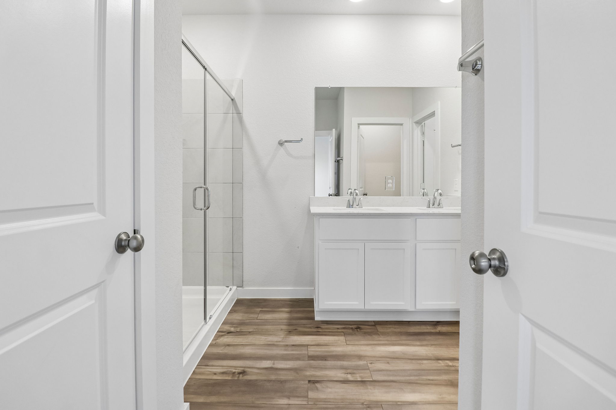 A bathroom with white cabinets.