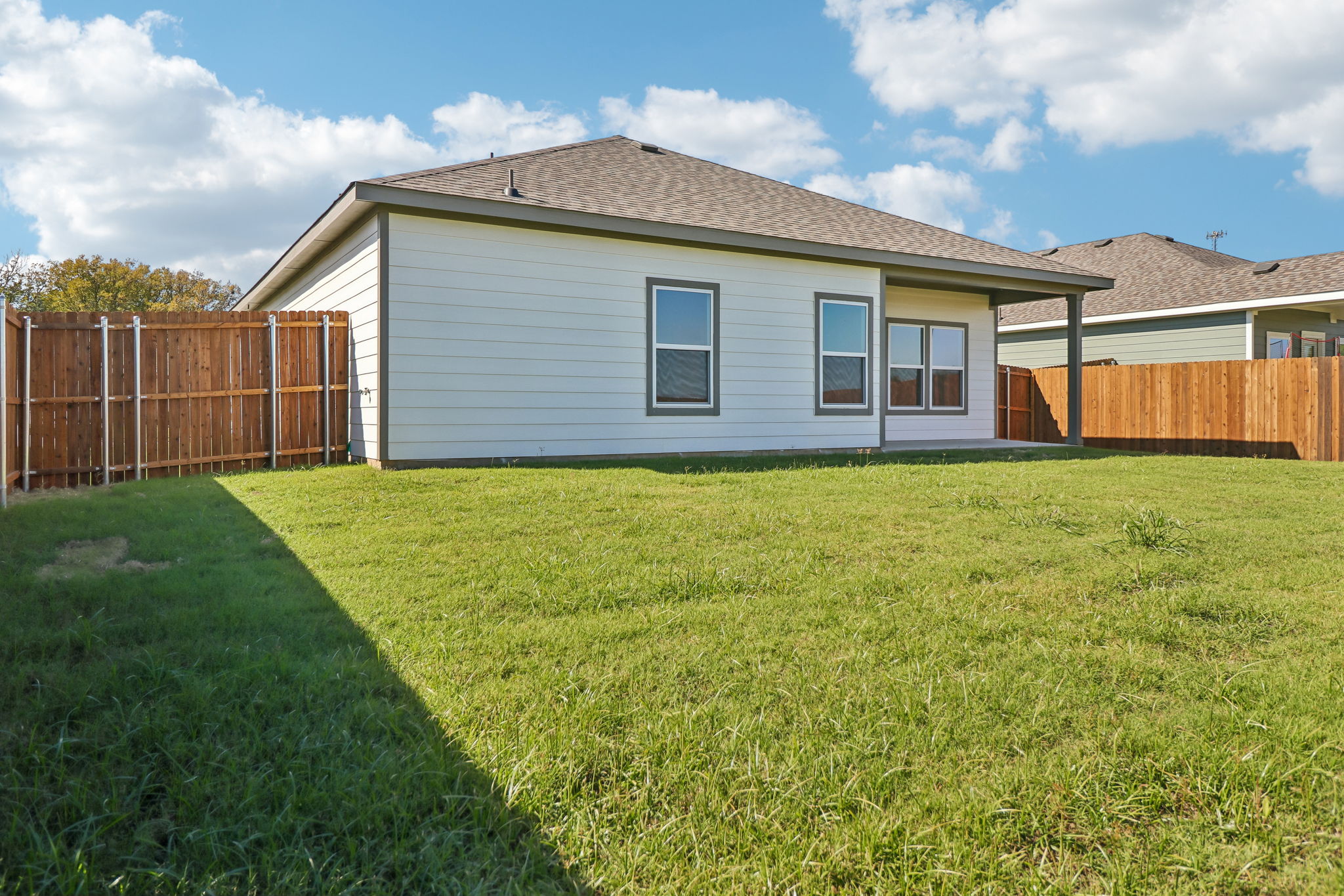 A house with a fence and grass.