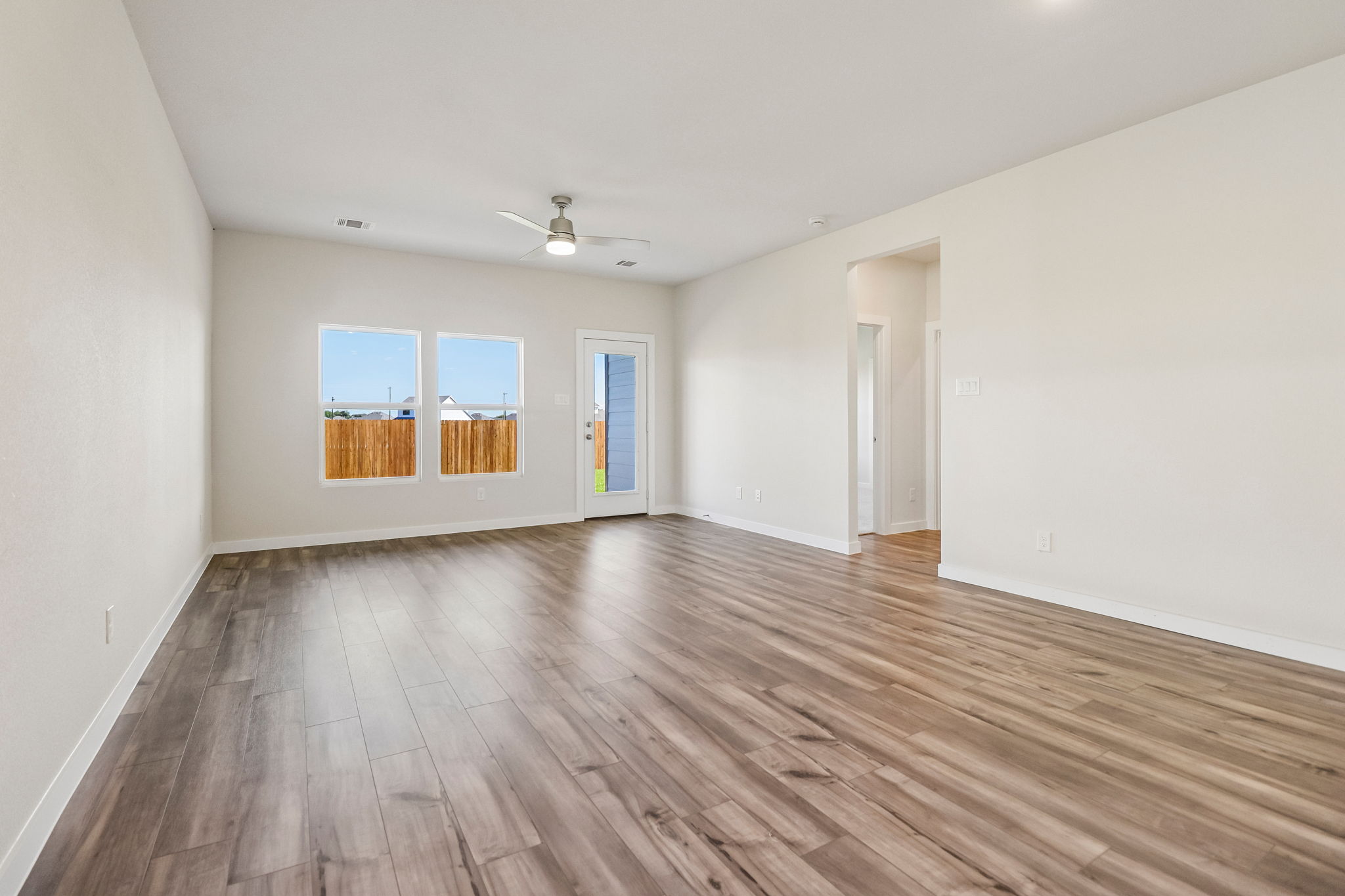 A room with a wood floor and a wood floor.