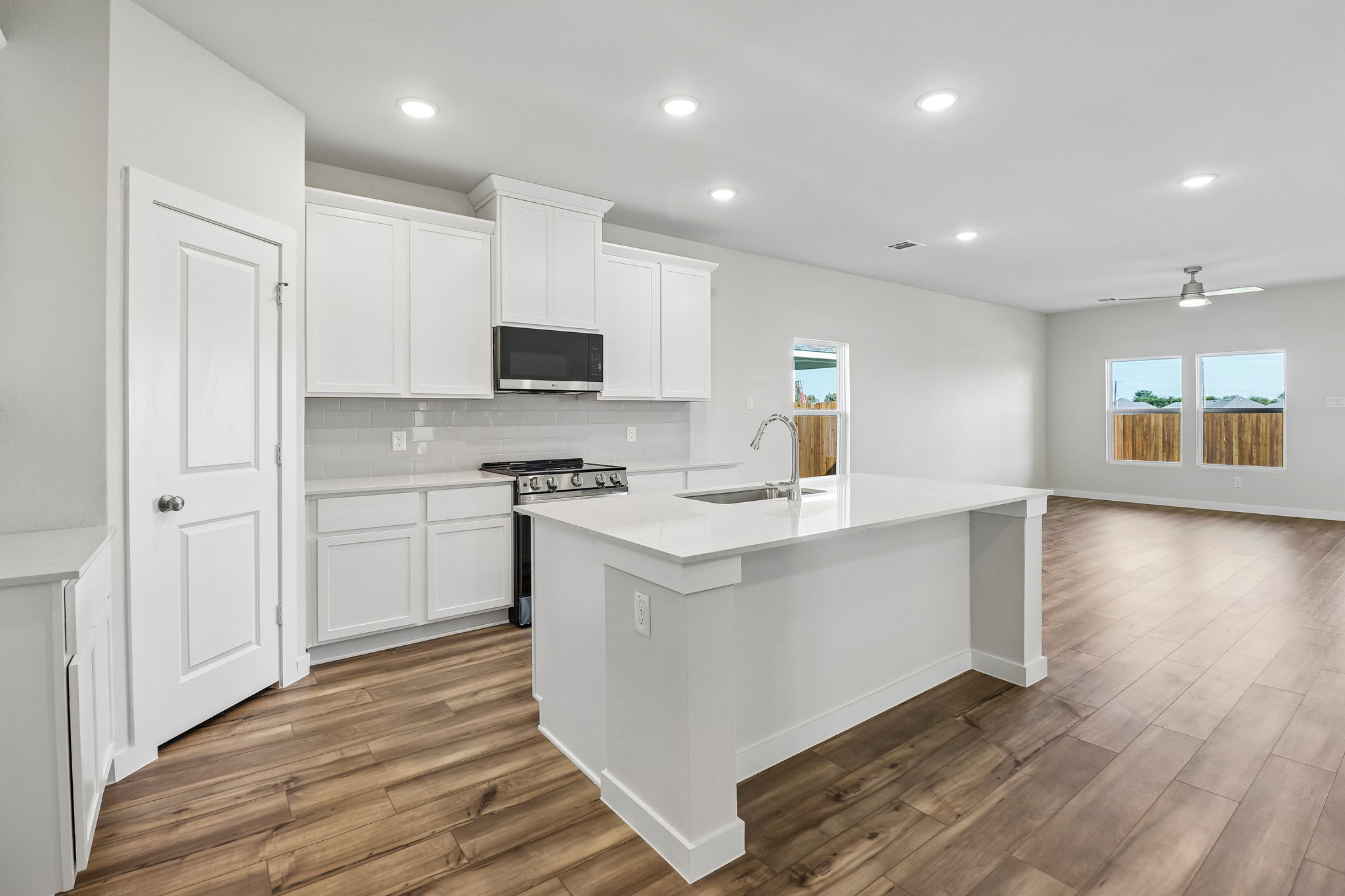 A kitchen with white cabinets.
