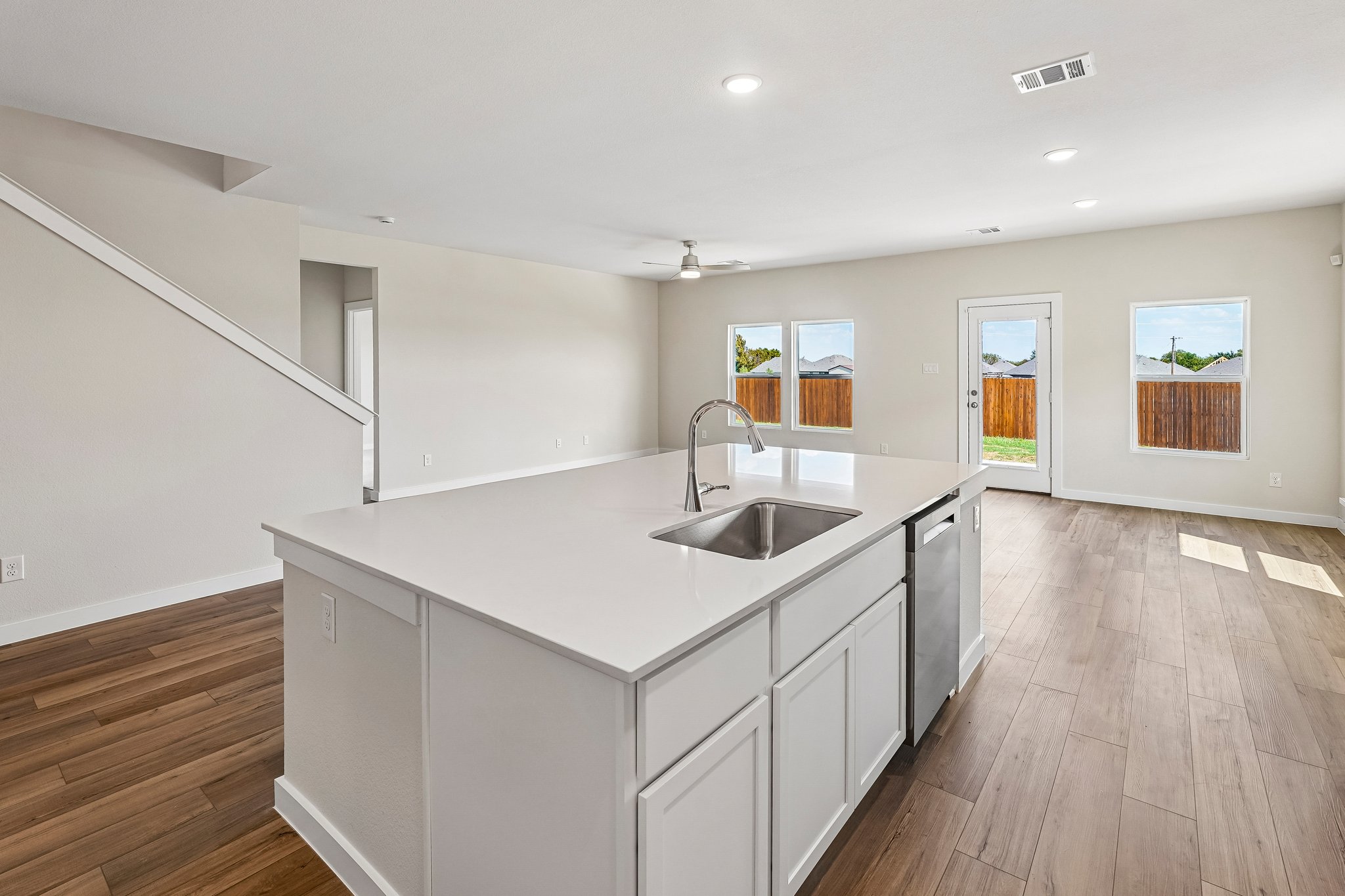 A kitchen with white cabinets.