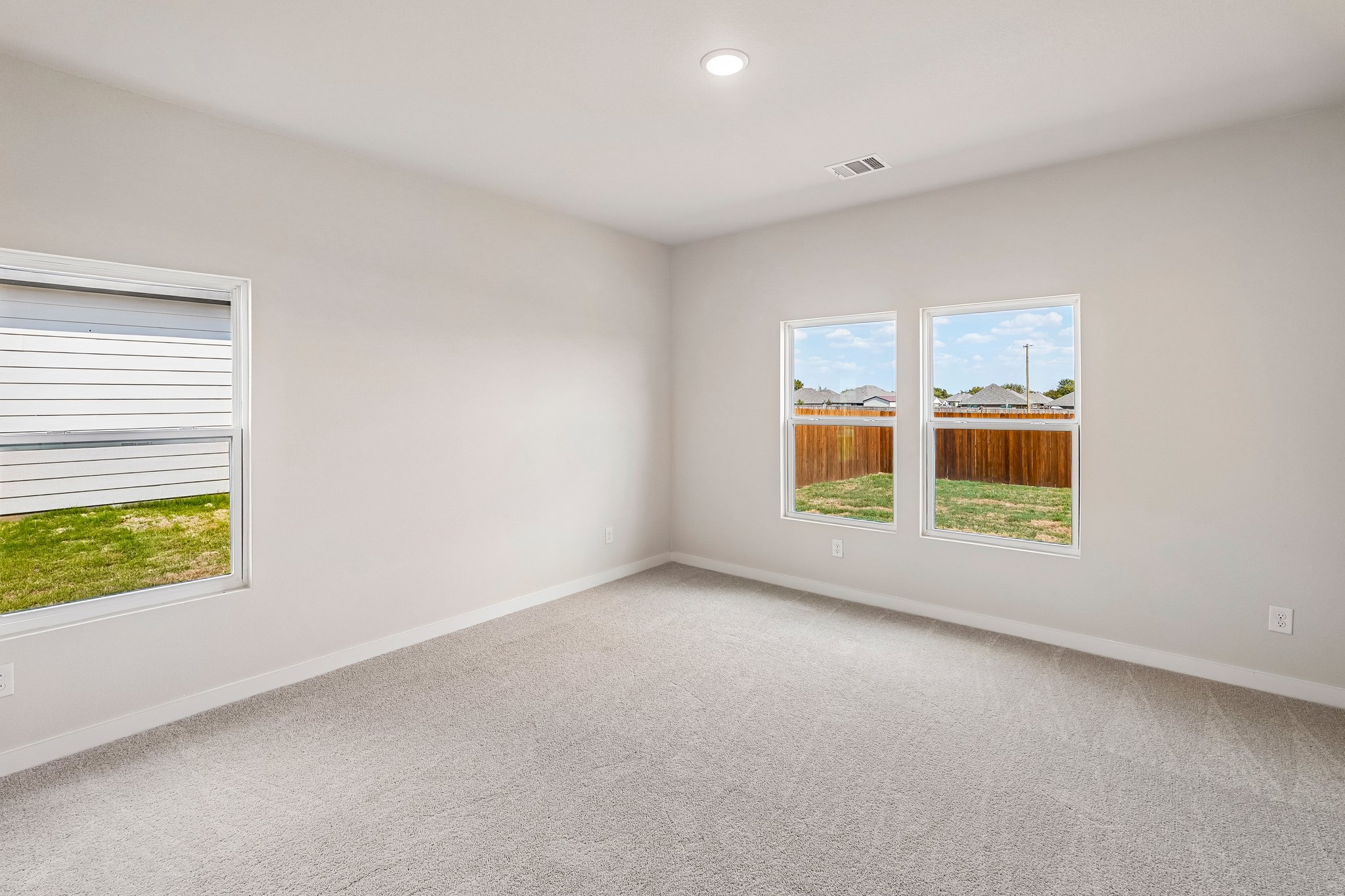 A room with a window and a carpet.