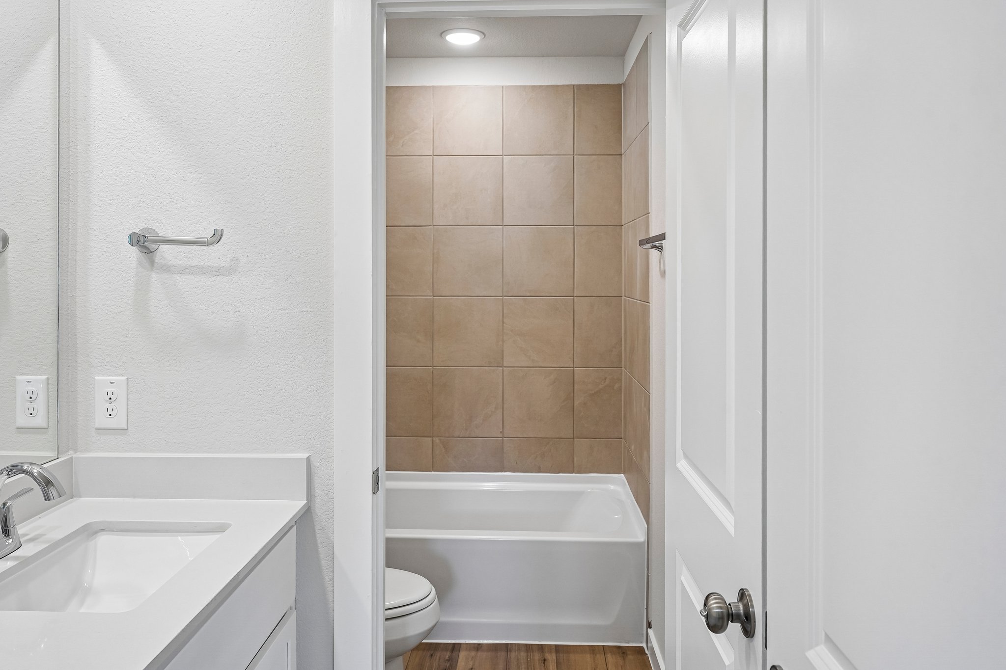 A bathroom with a tub sink and toilet.