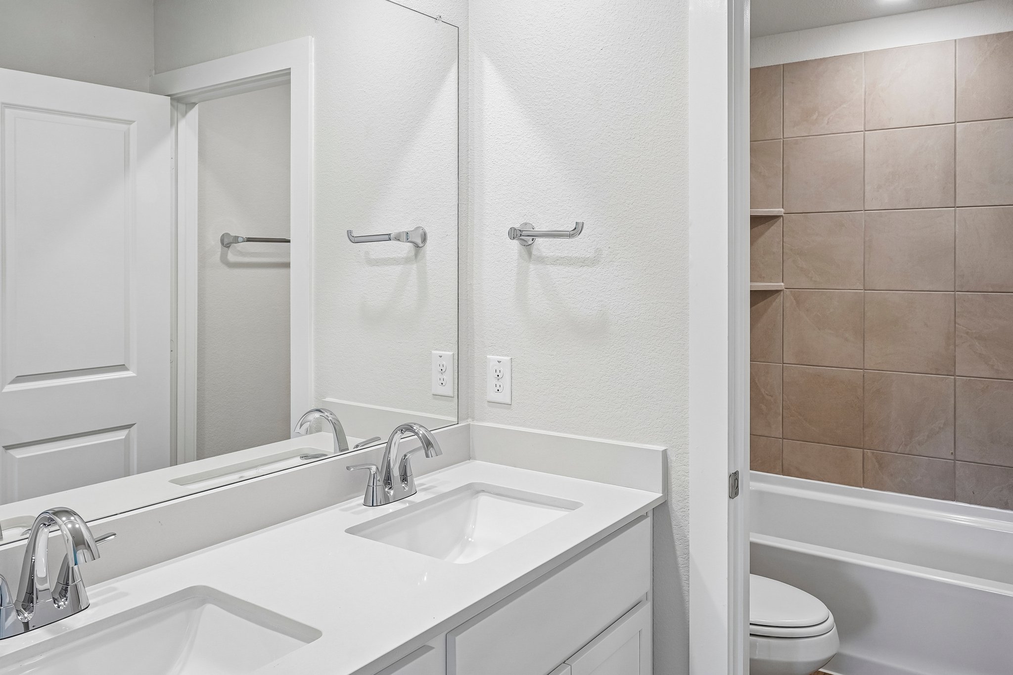 A bathroom with a sink and a toilet.