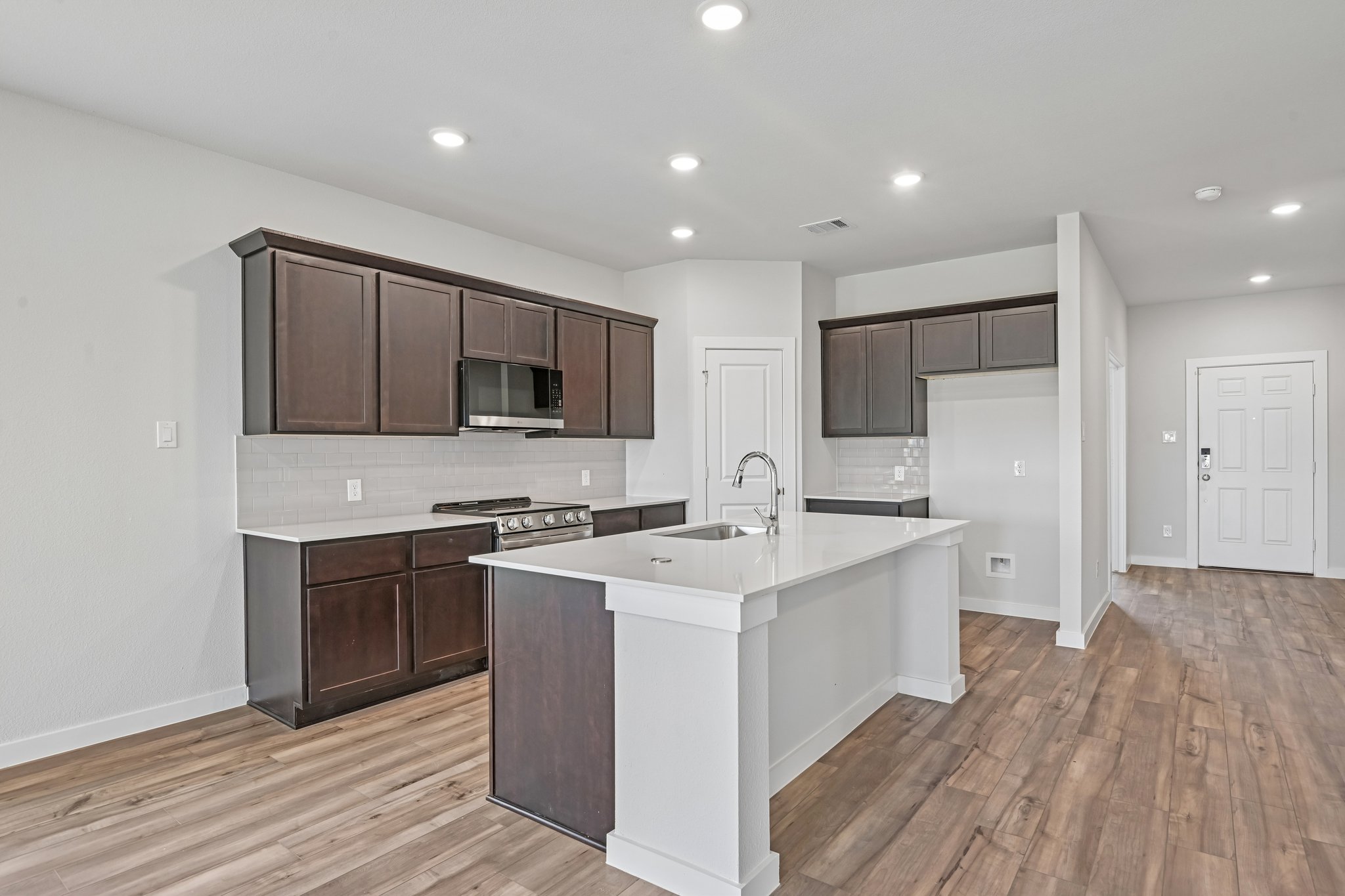 A kitchen with wooden cabinets.
