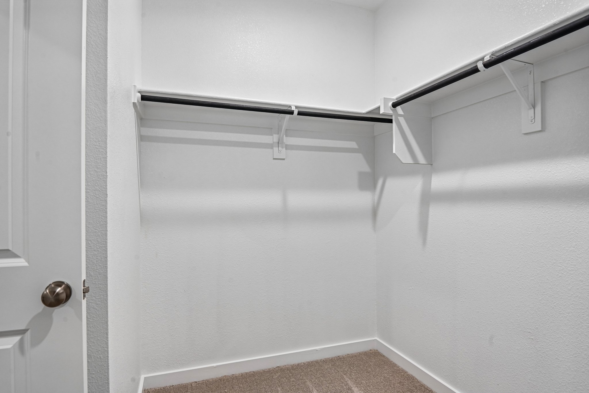 A white staircase with a metal railing.