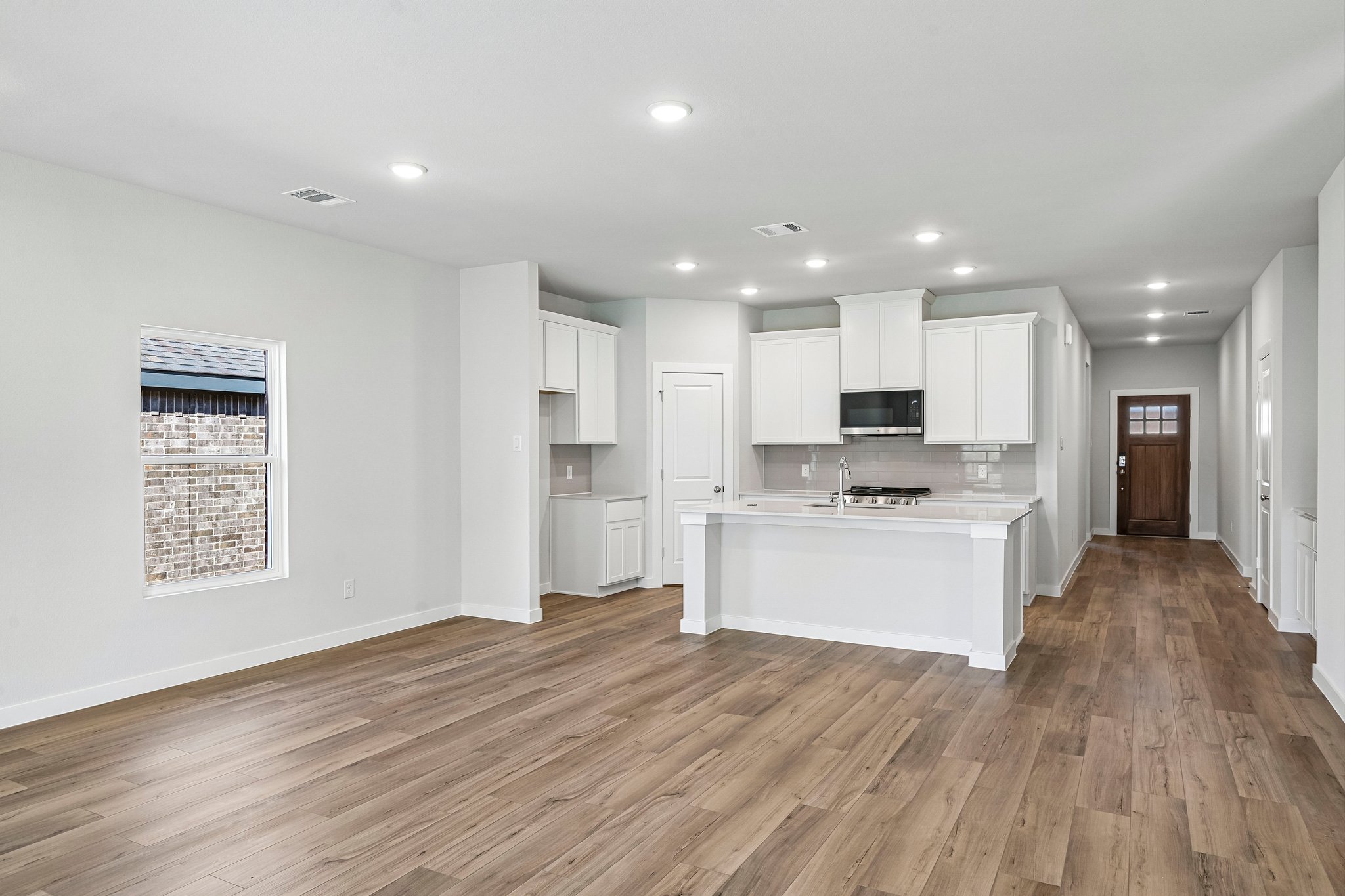 A large kitchen with white cabinets.