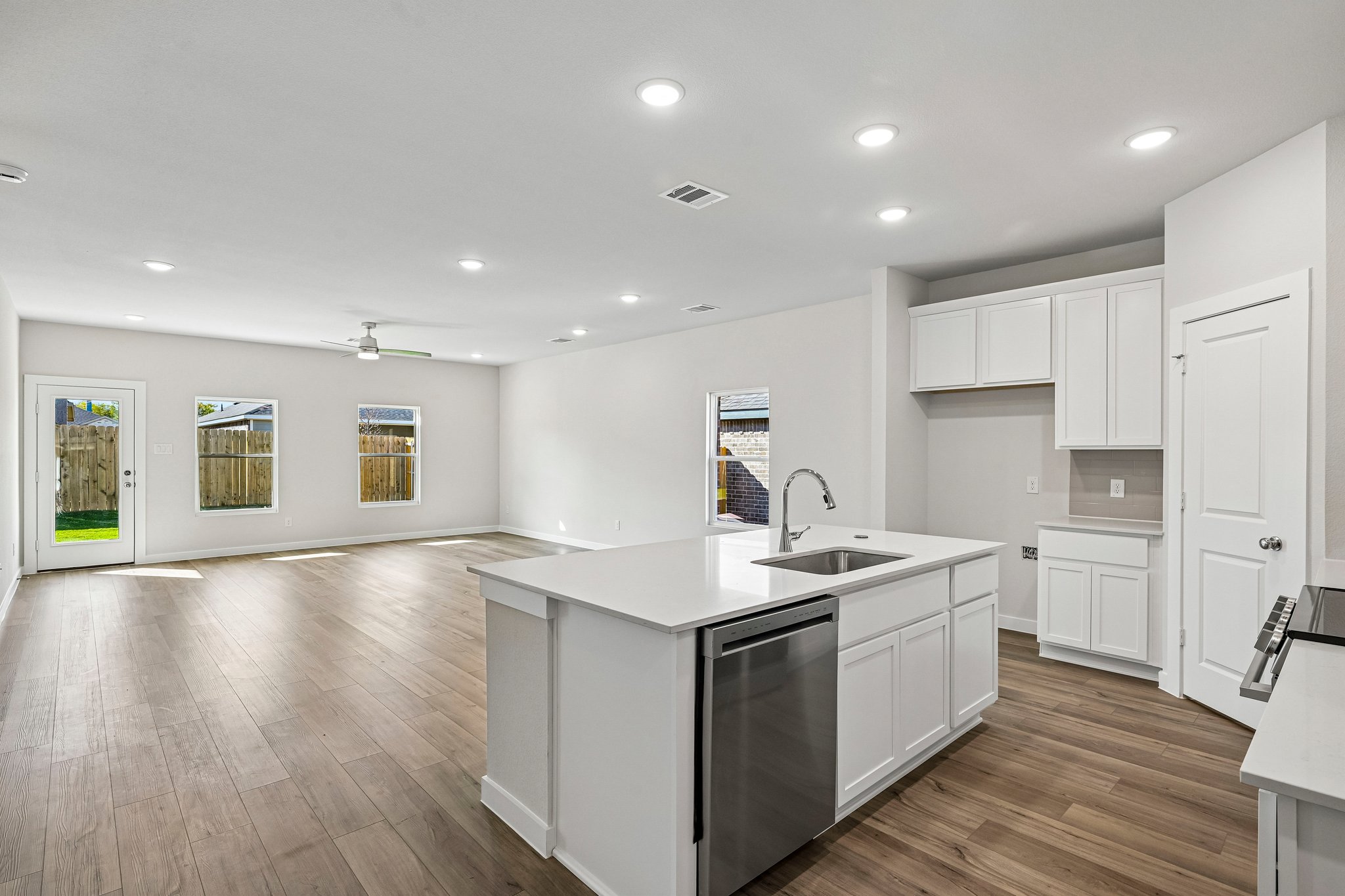 A kitchen with white cabinets.