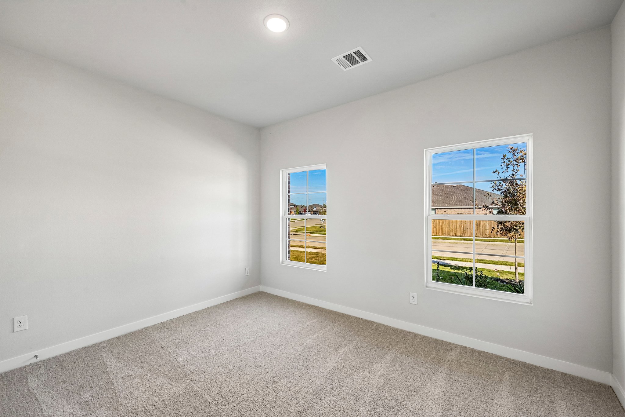 A room with a window and a carpet.