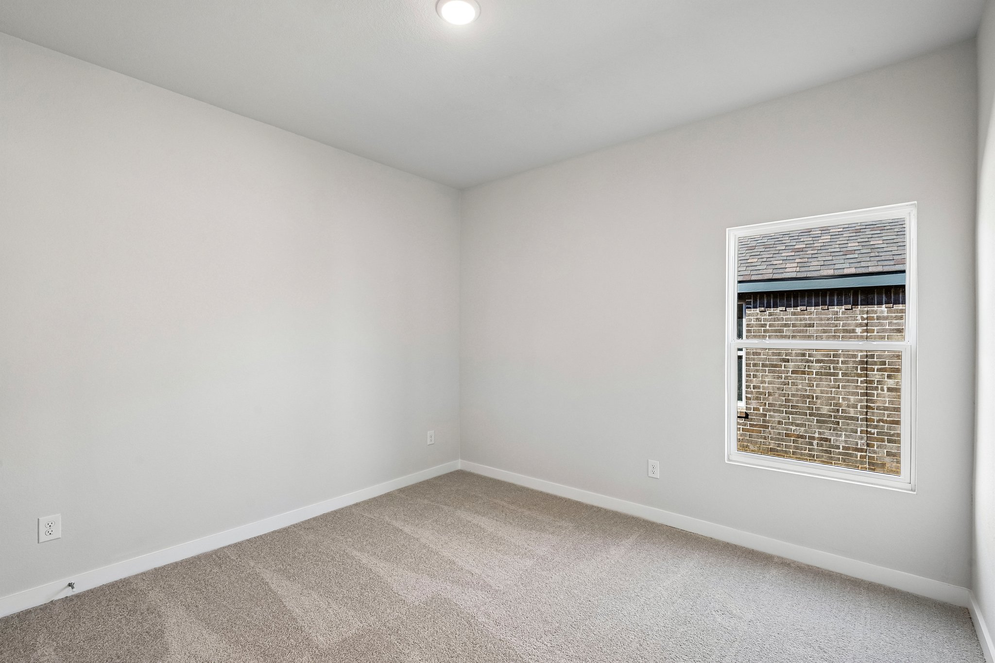 A room with a window and a vent.