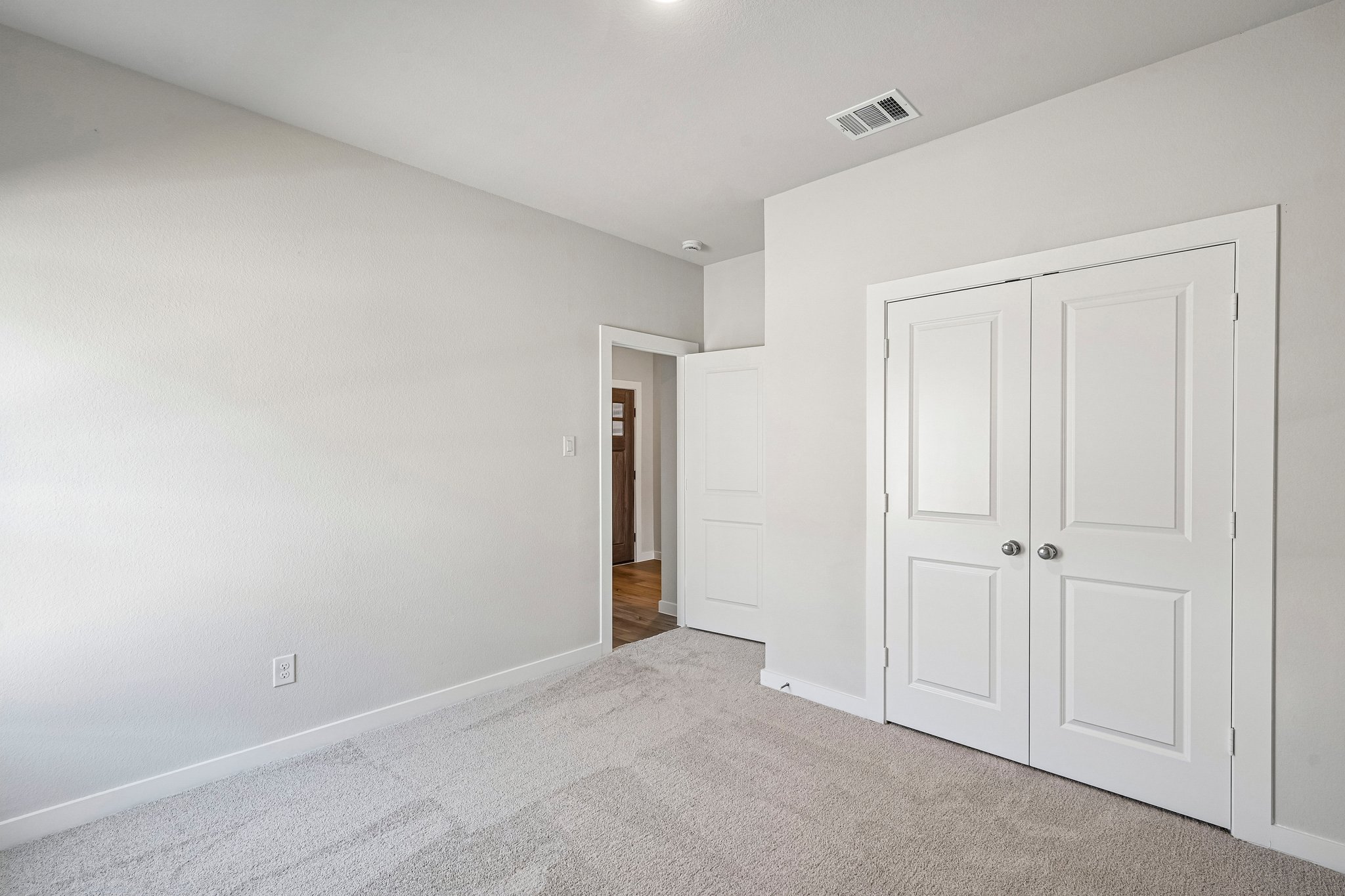 A hallway with white doors.