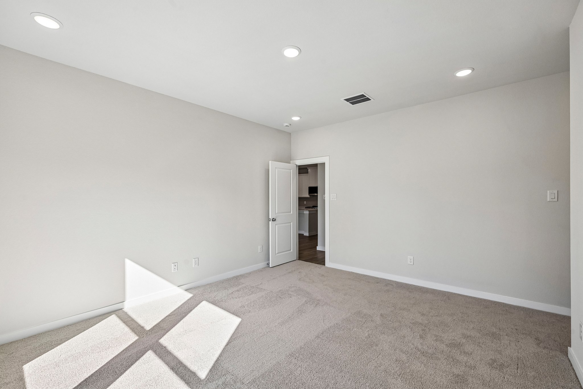 A room with a carpet and a rug.