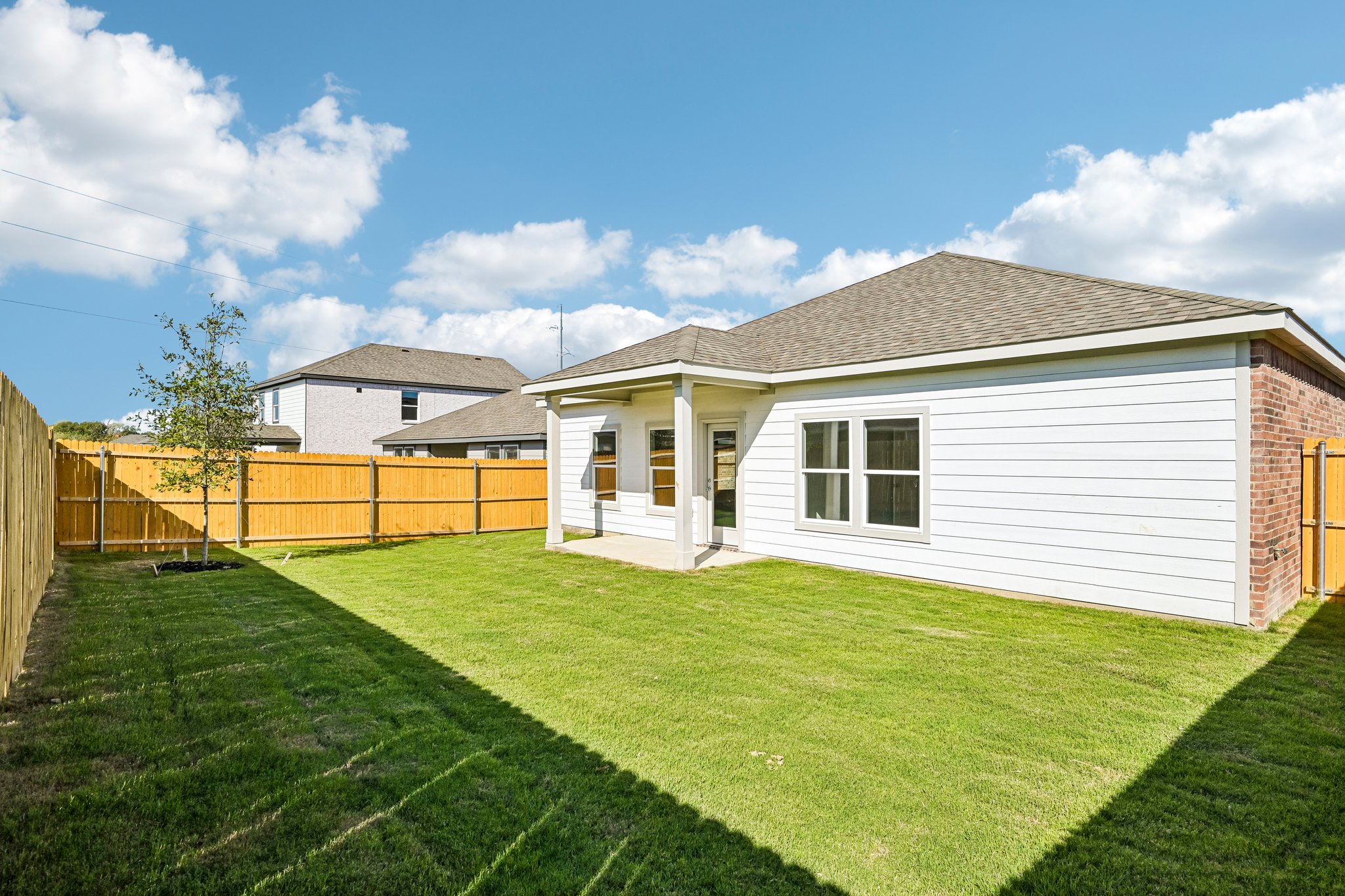 A house with a fence and grass.