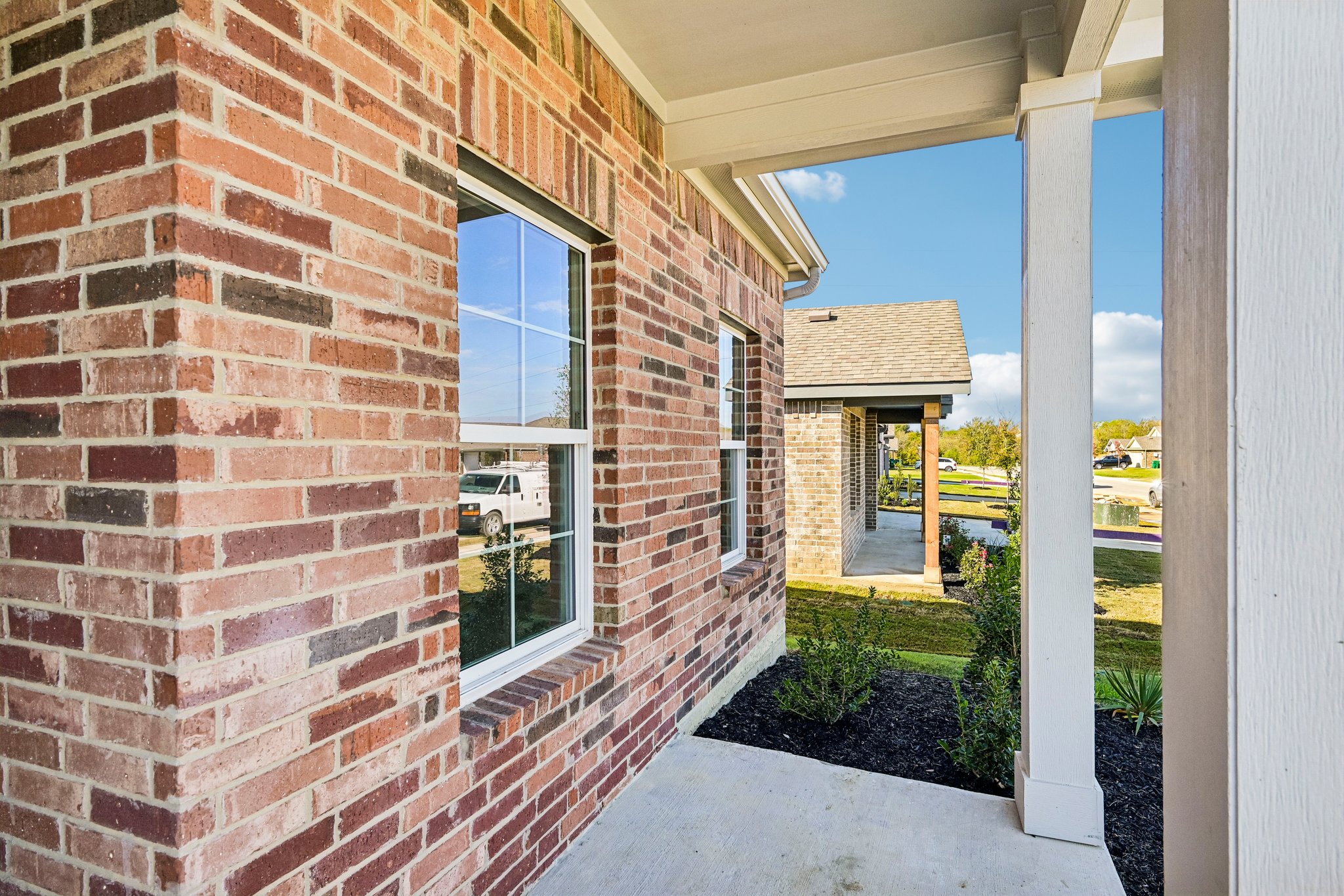 A brick building with a glass door.