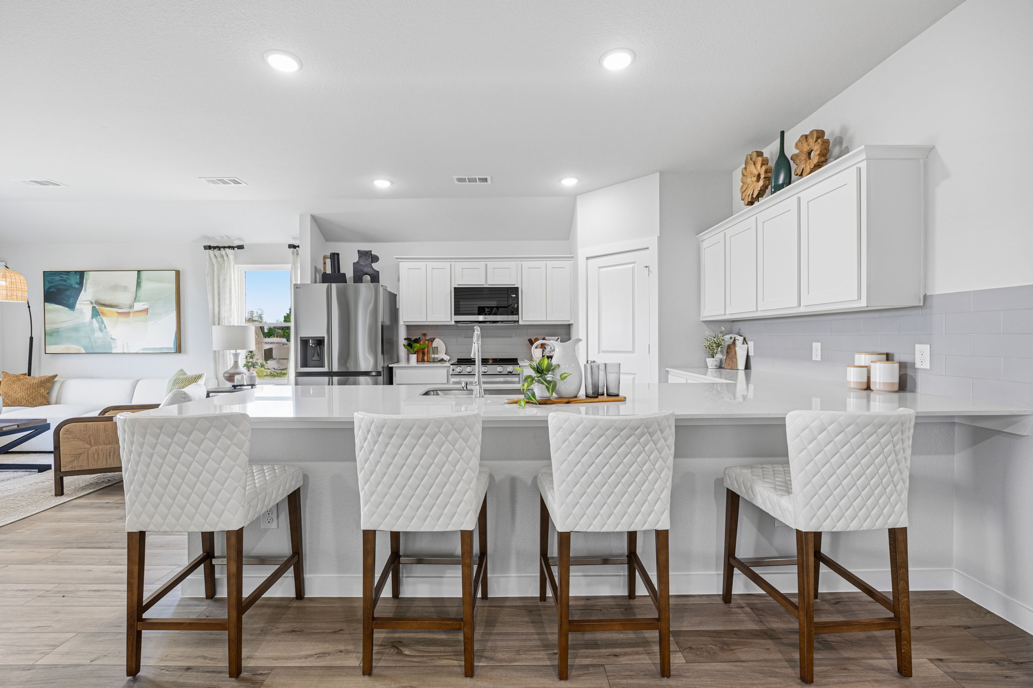 A kitchen with white cabinets.