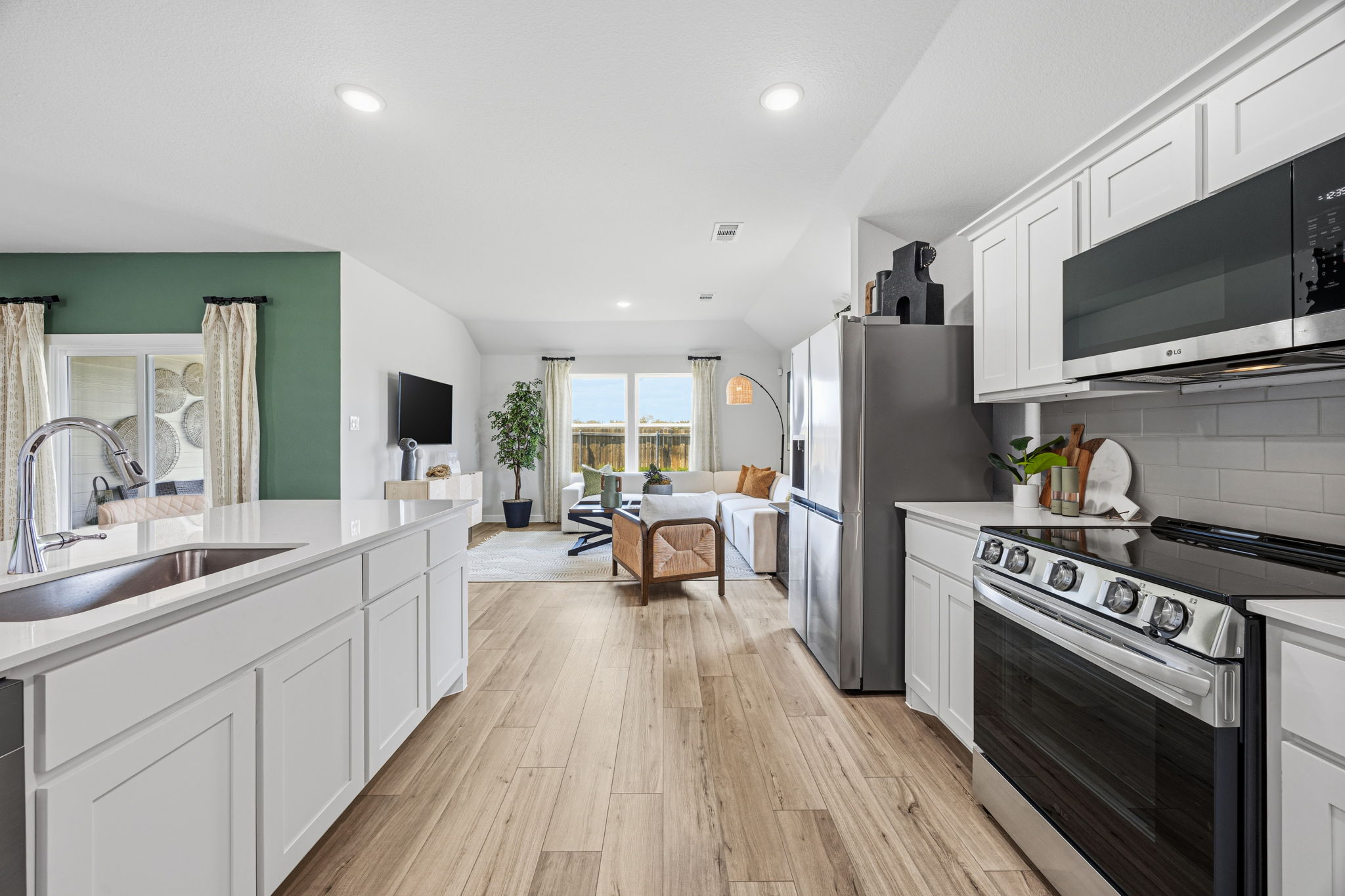 A kitchen with a wood floor.