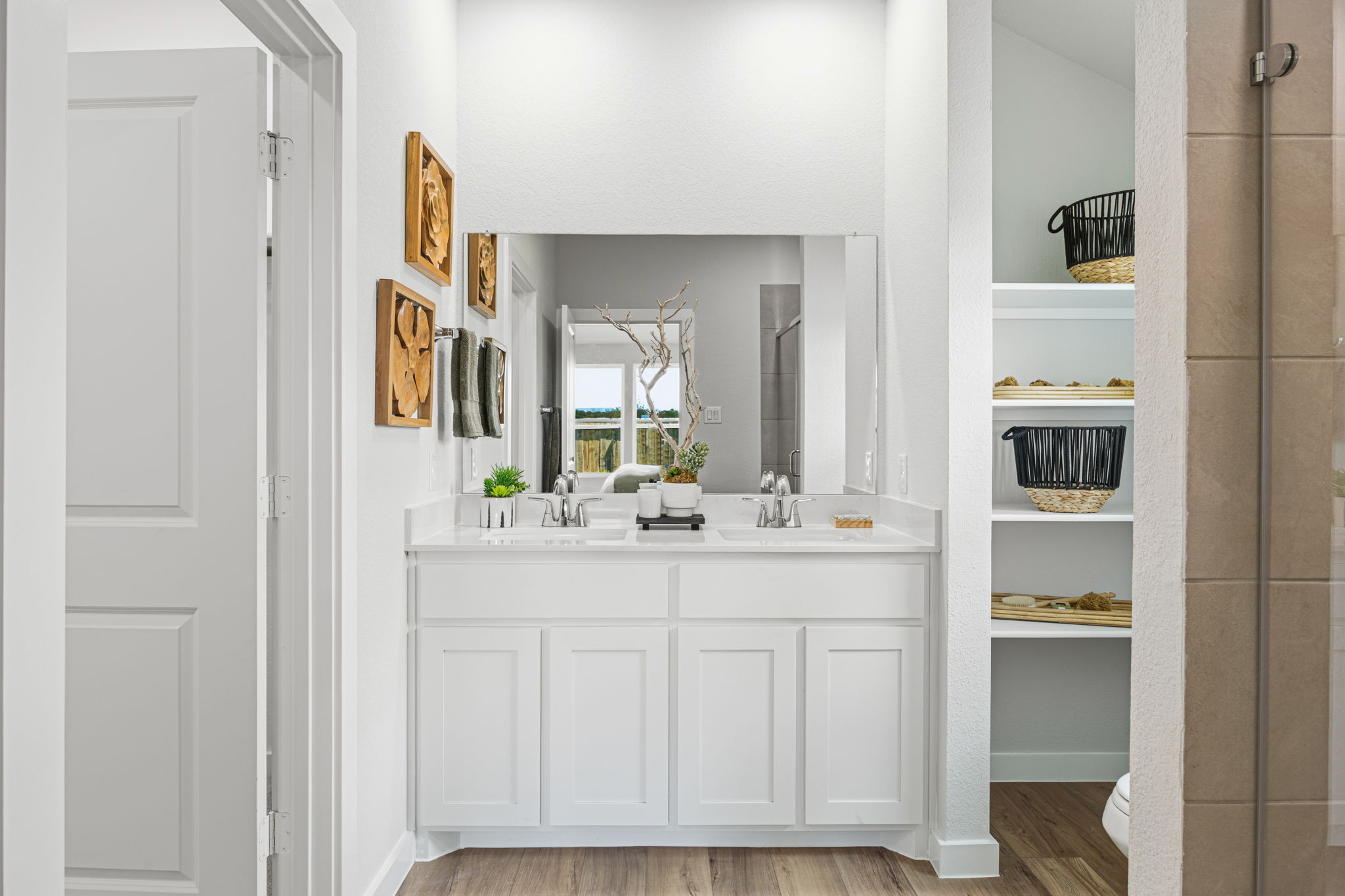 A bathroom with white cabinets.