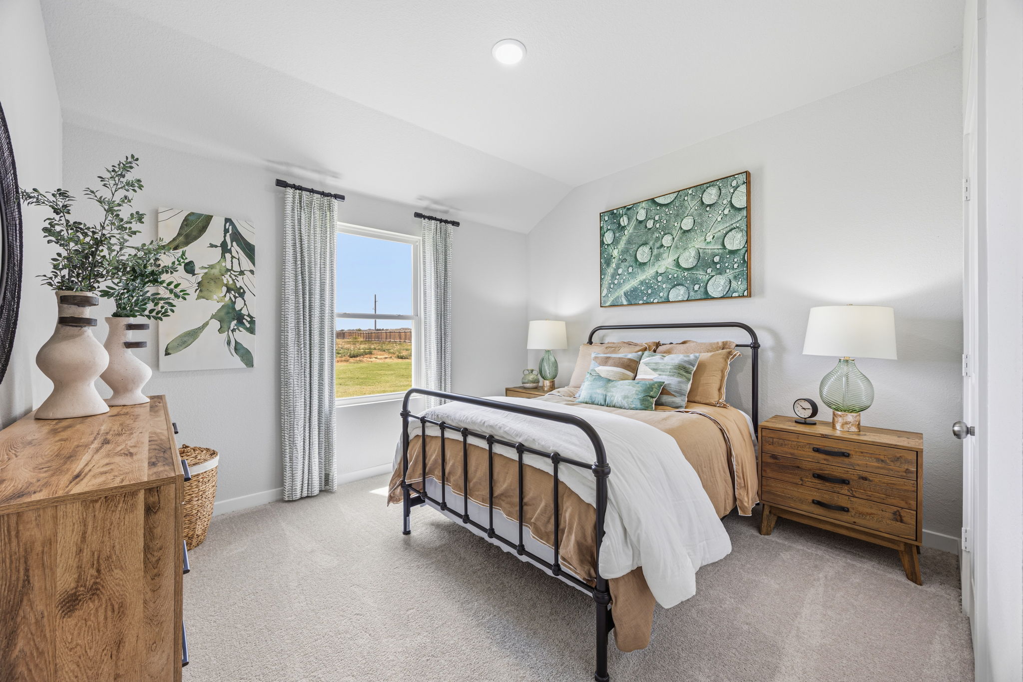 A bedroom with a large window.