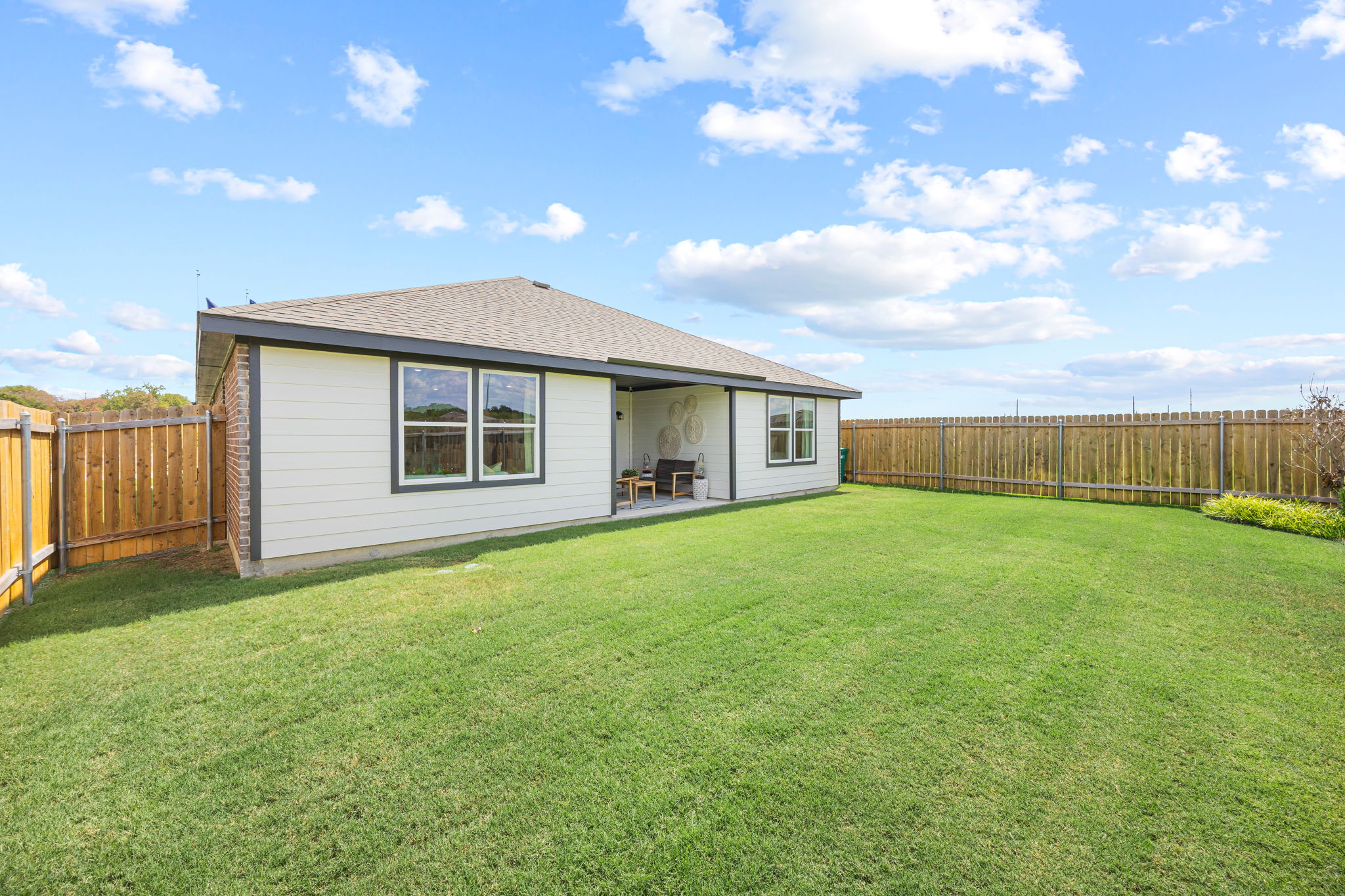 A house with a fence and grass.