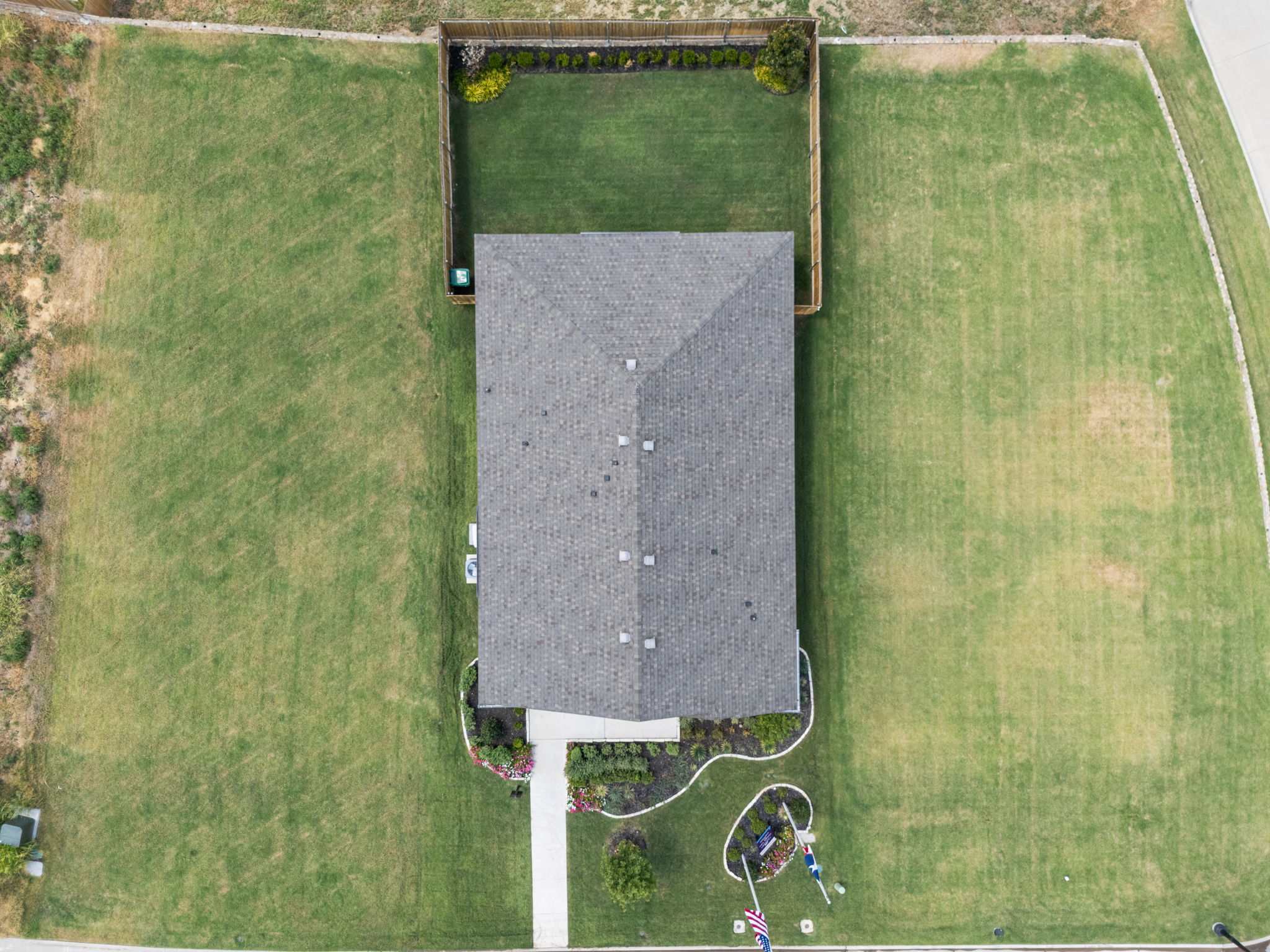 A solar panel on a grass field.