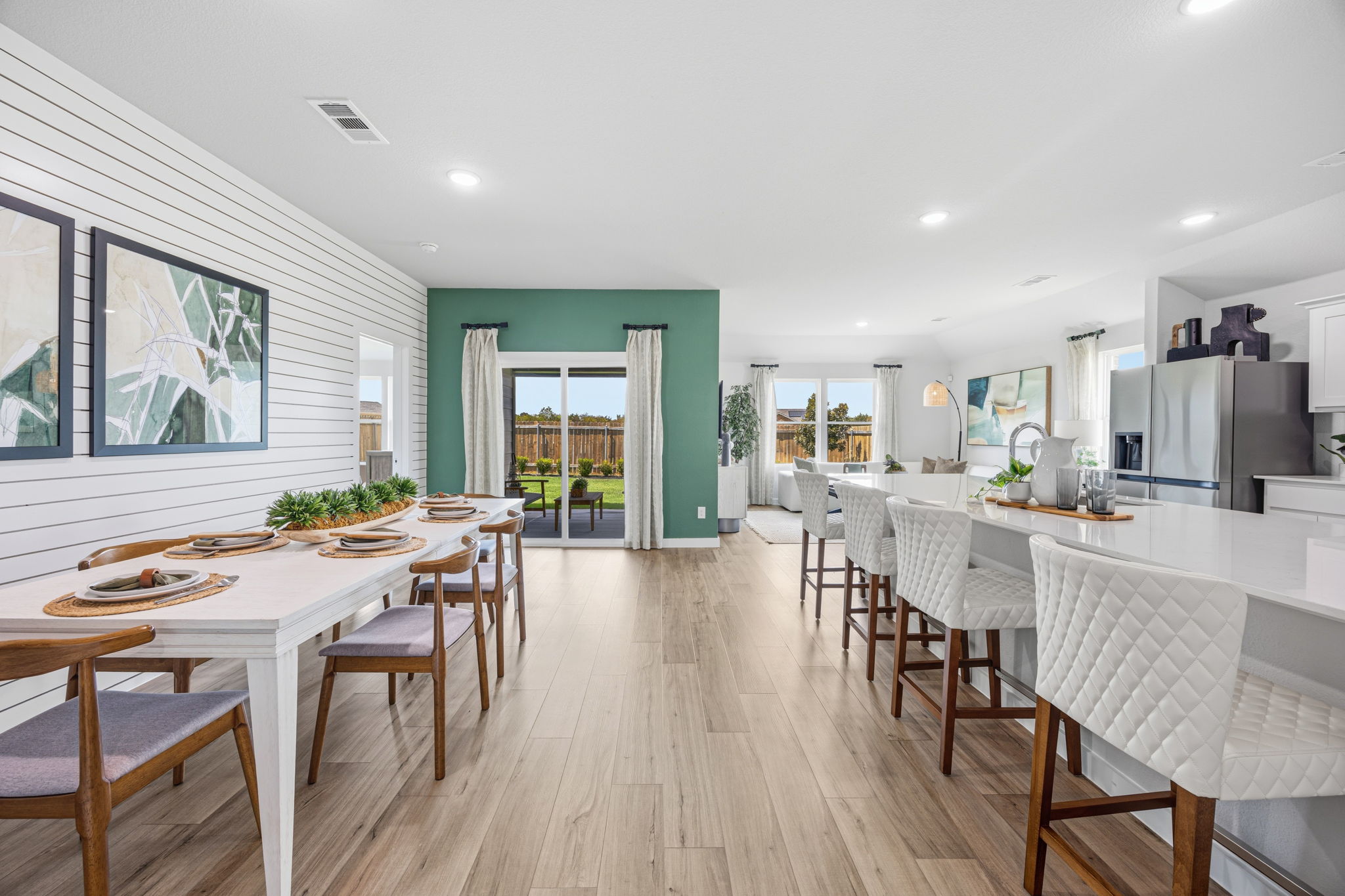 A large kitchen with tables and chairs.