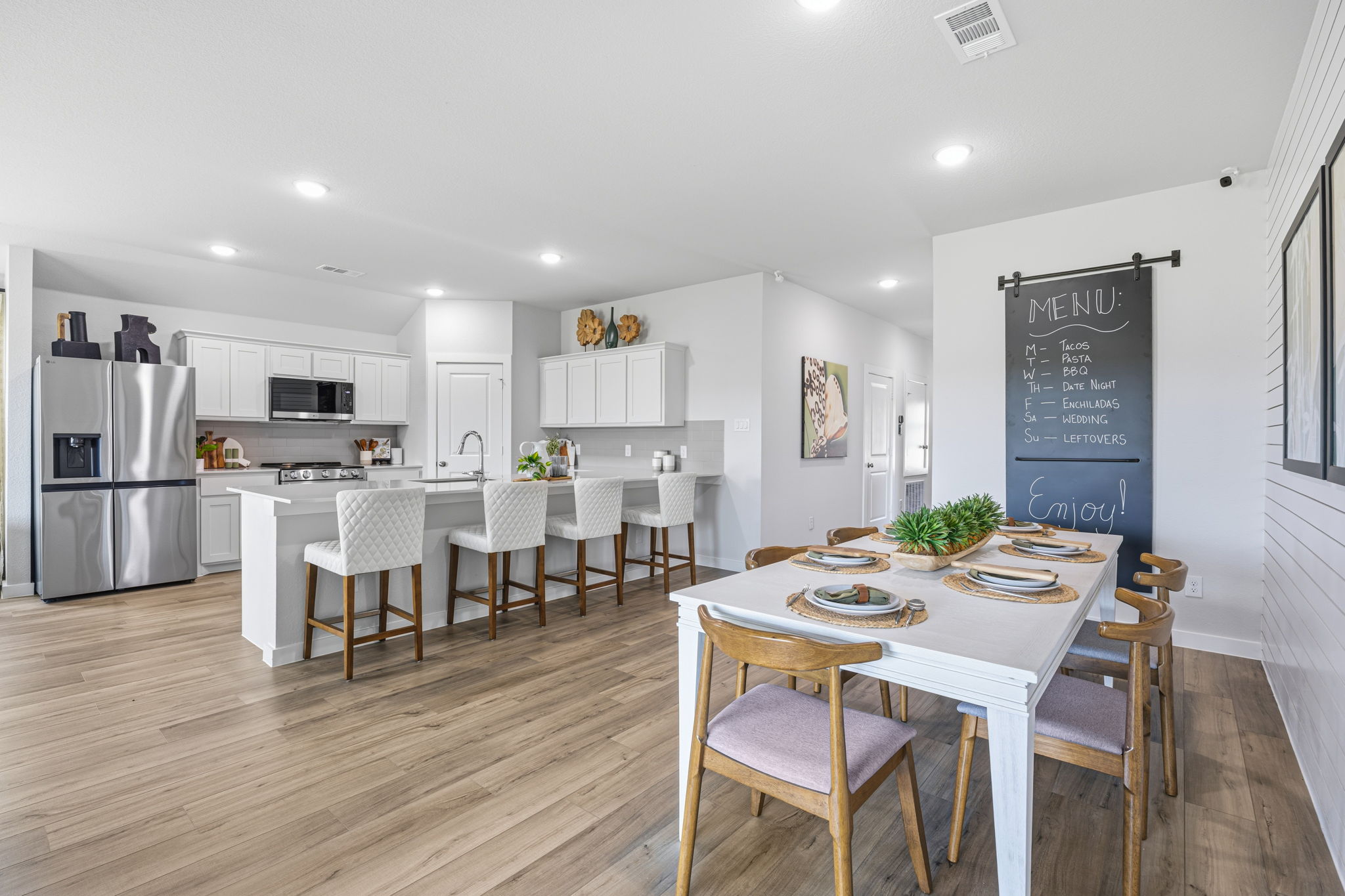 A large kitchen with a dining table.