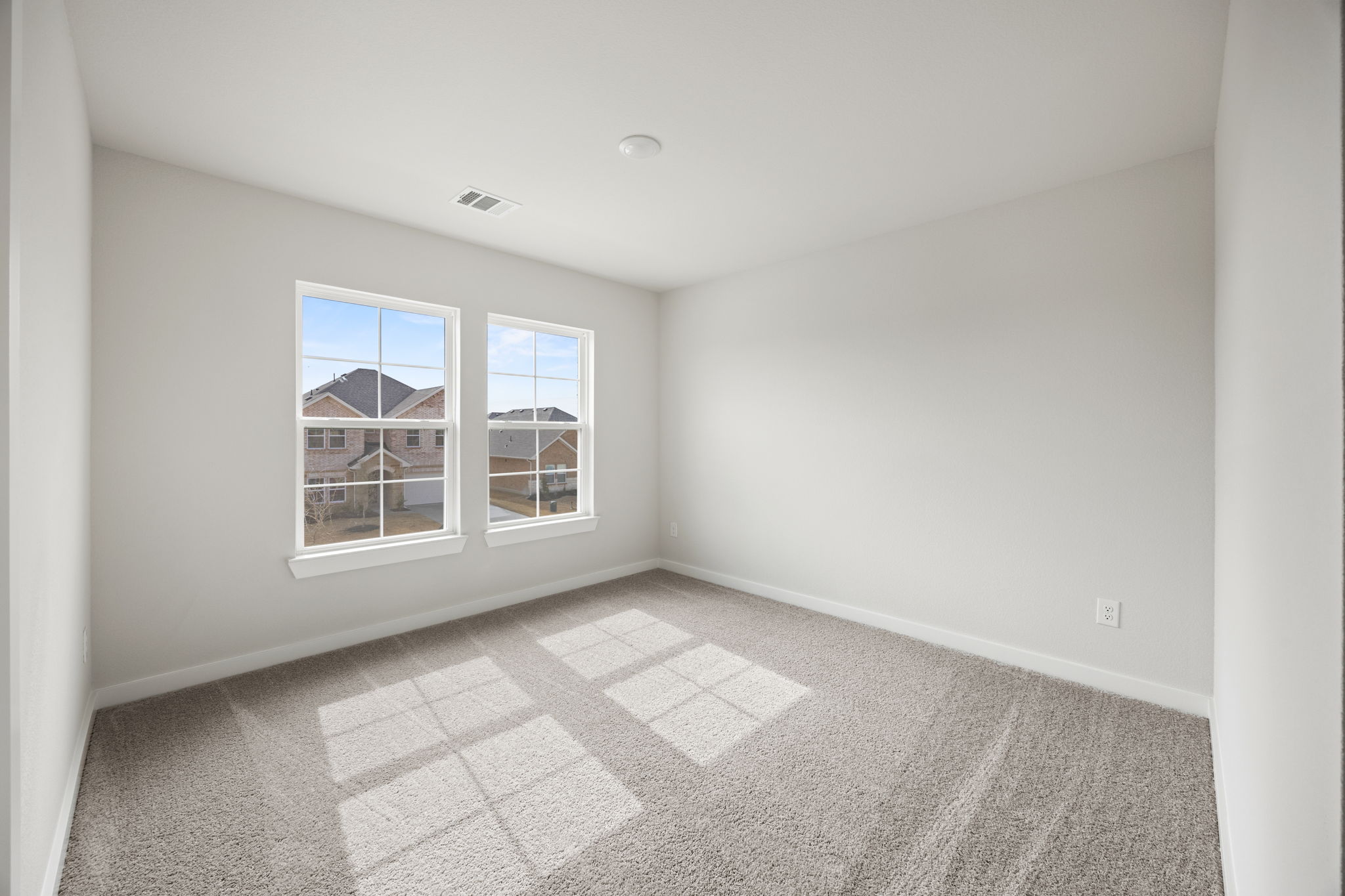 A room with a window and a tile floor.