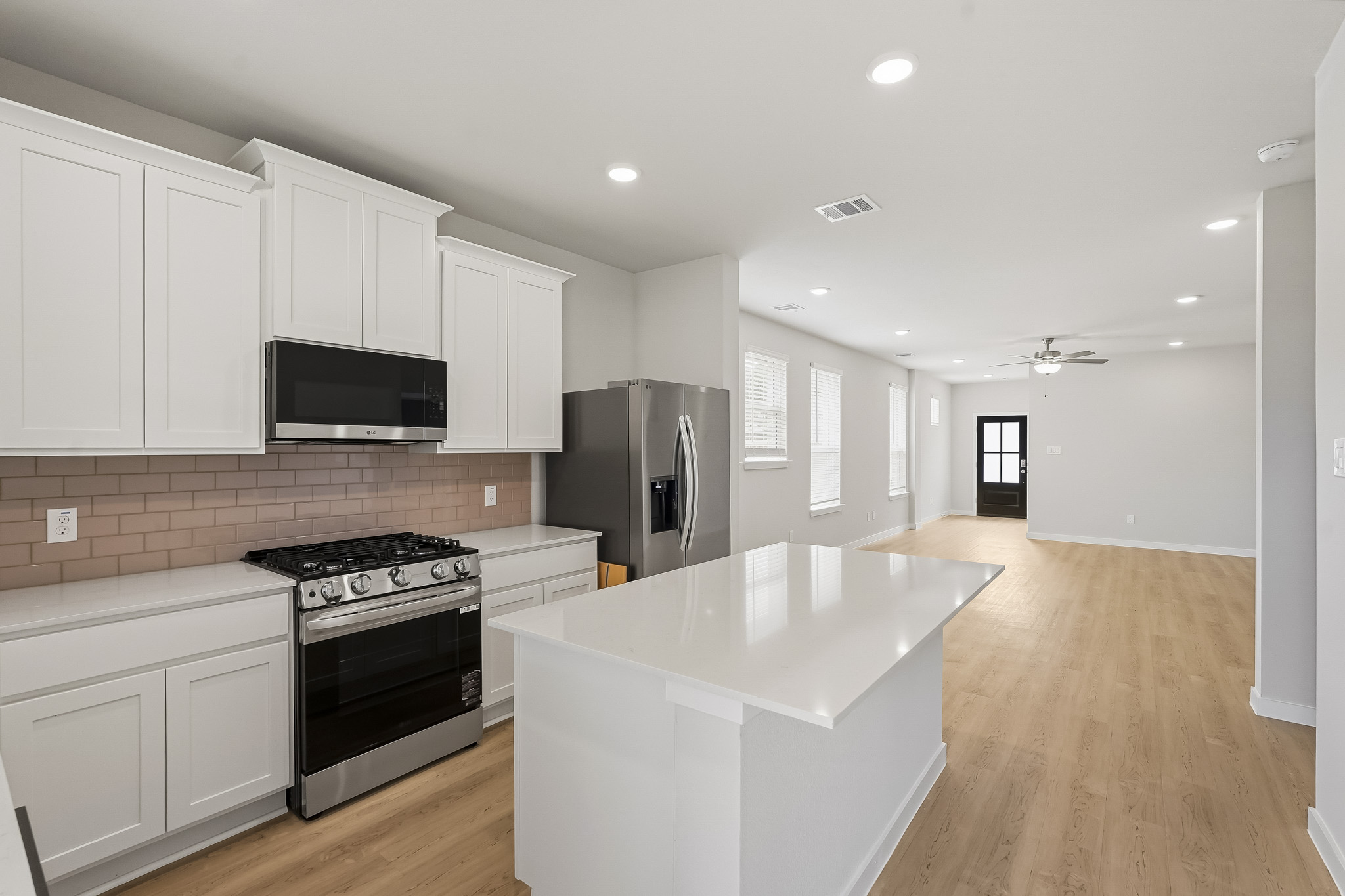 A kitchen with white cabinets.