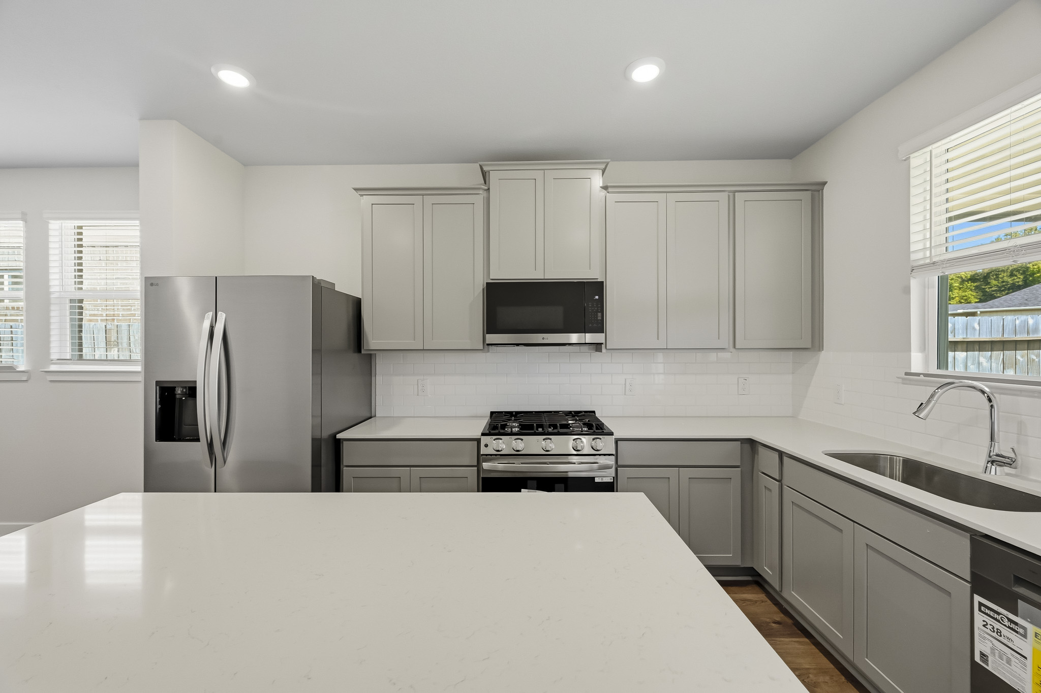 A kitchen with white cabinets.
