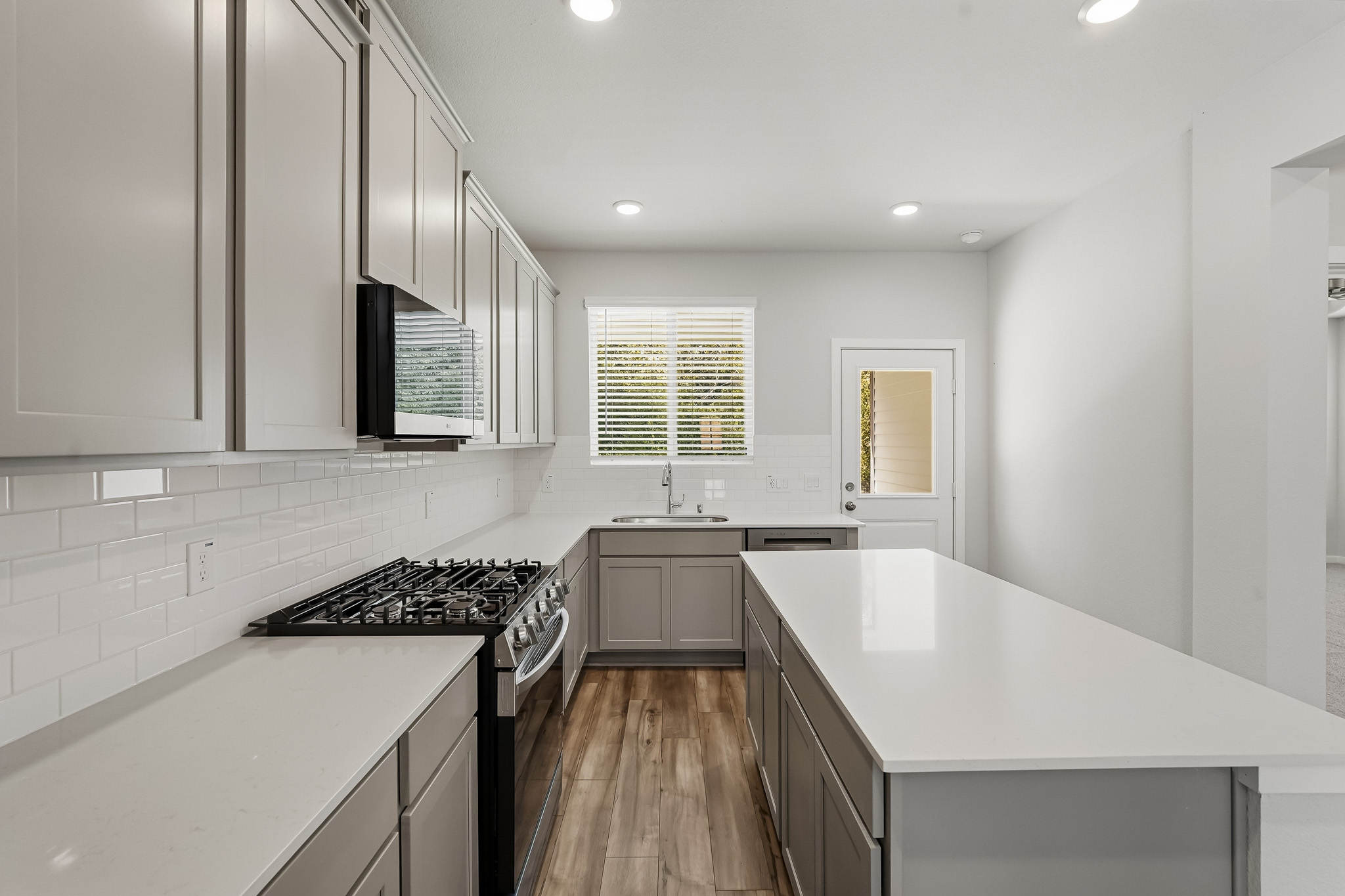 A kitchen with white cabinets.