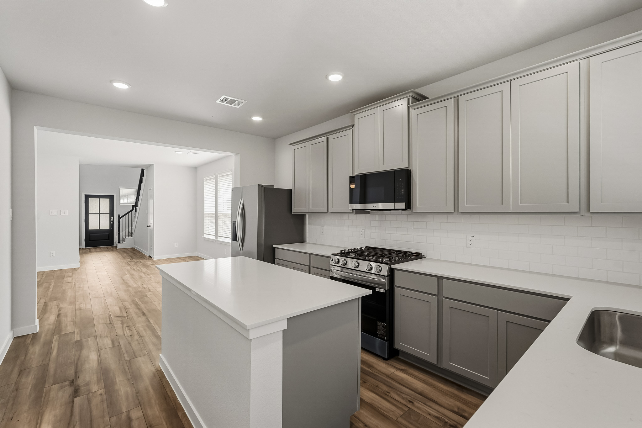 A kitchen with white cabinets.