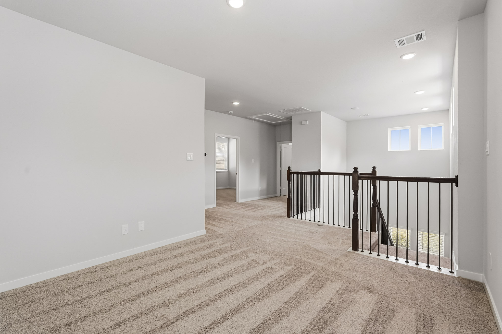 A long hallway with a railing.