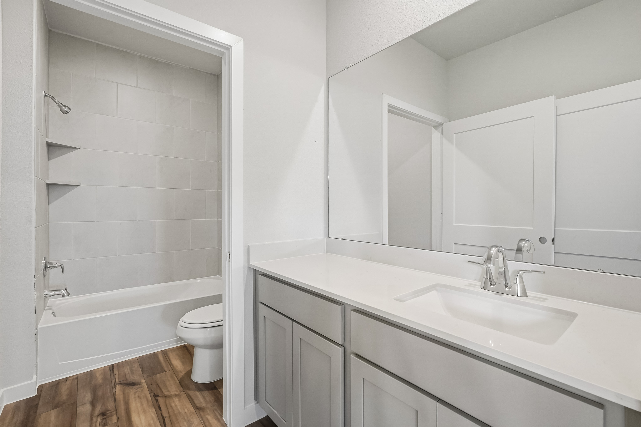 A bathroom with a tub sink and toilet.