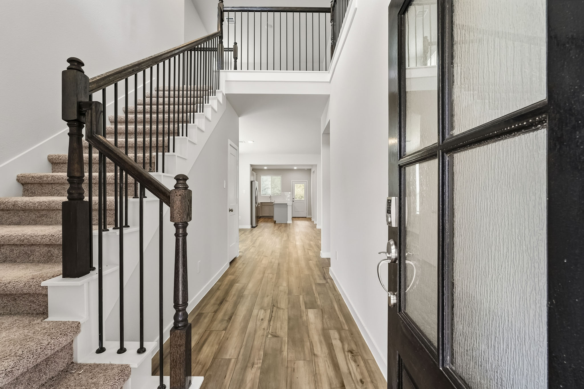 A long hallway with black railings.
