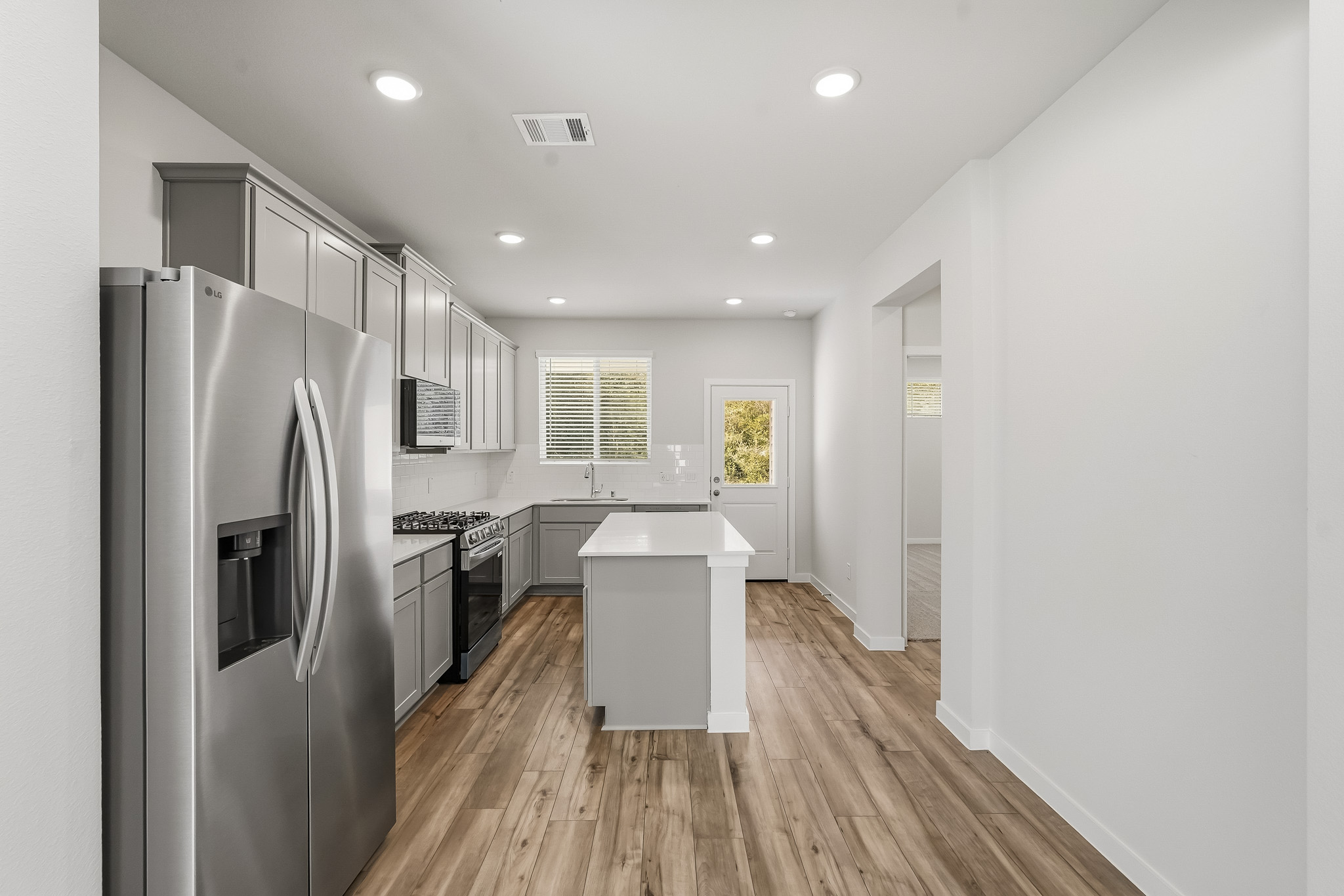 A kitchen with white cabinets.