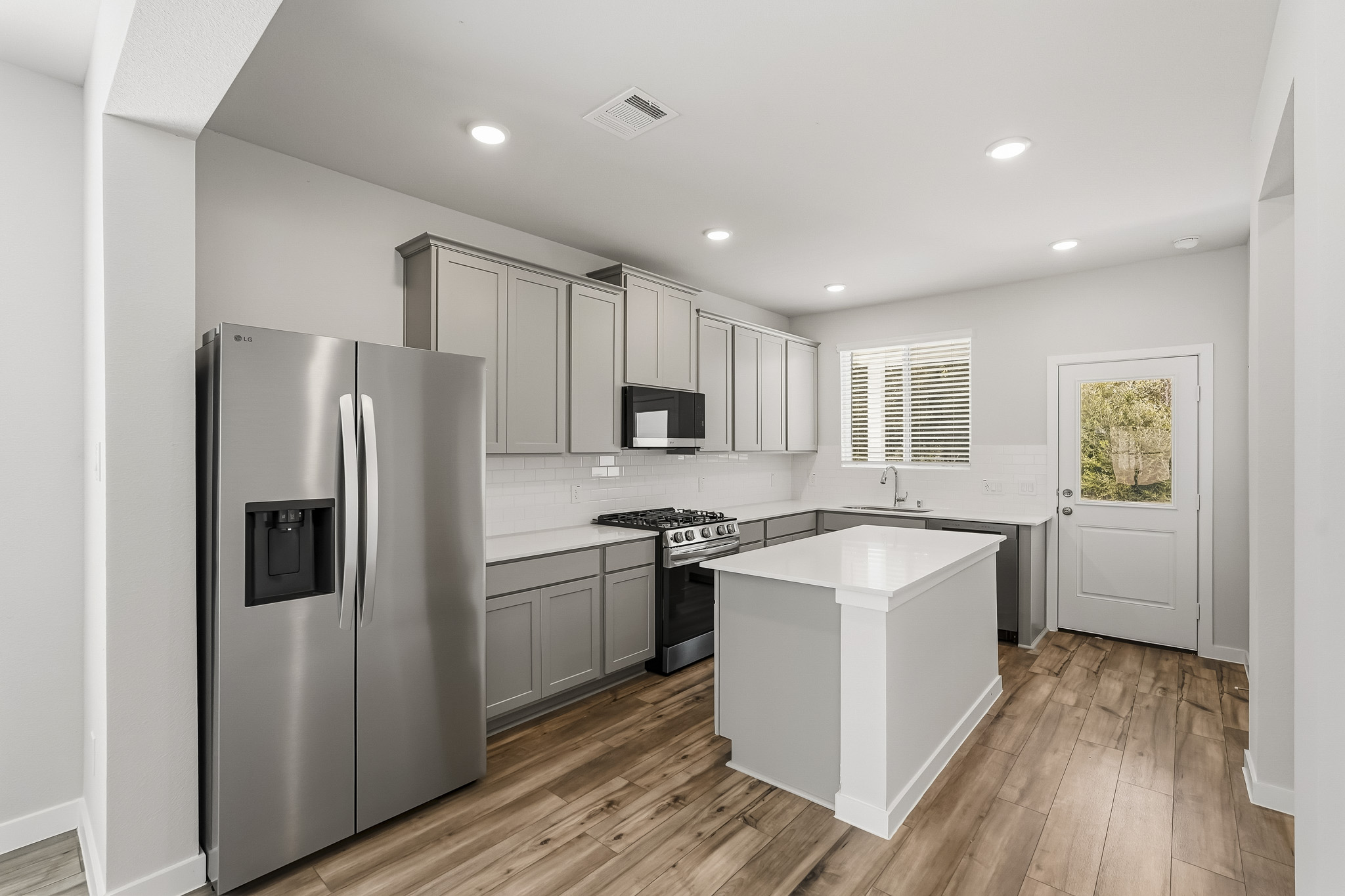 A kitchen with white cabinets.