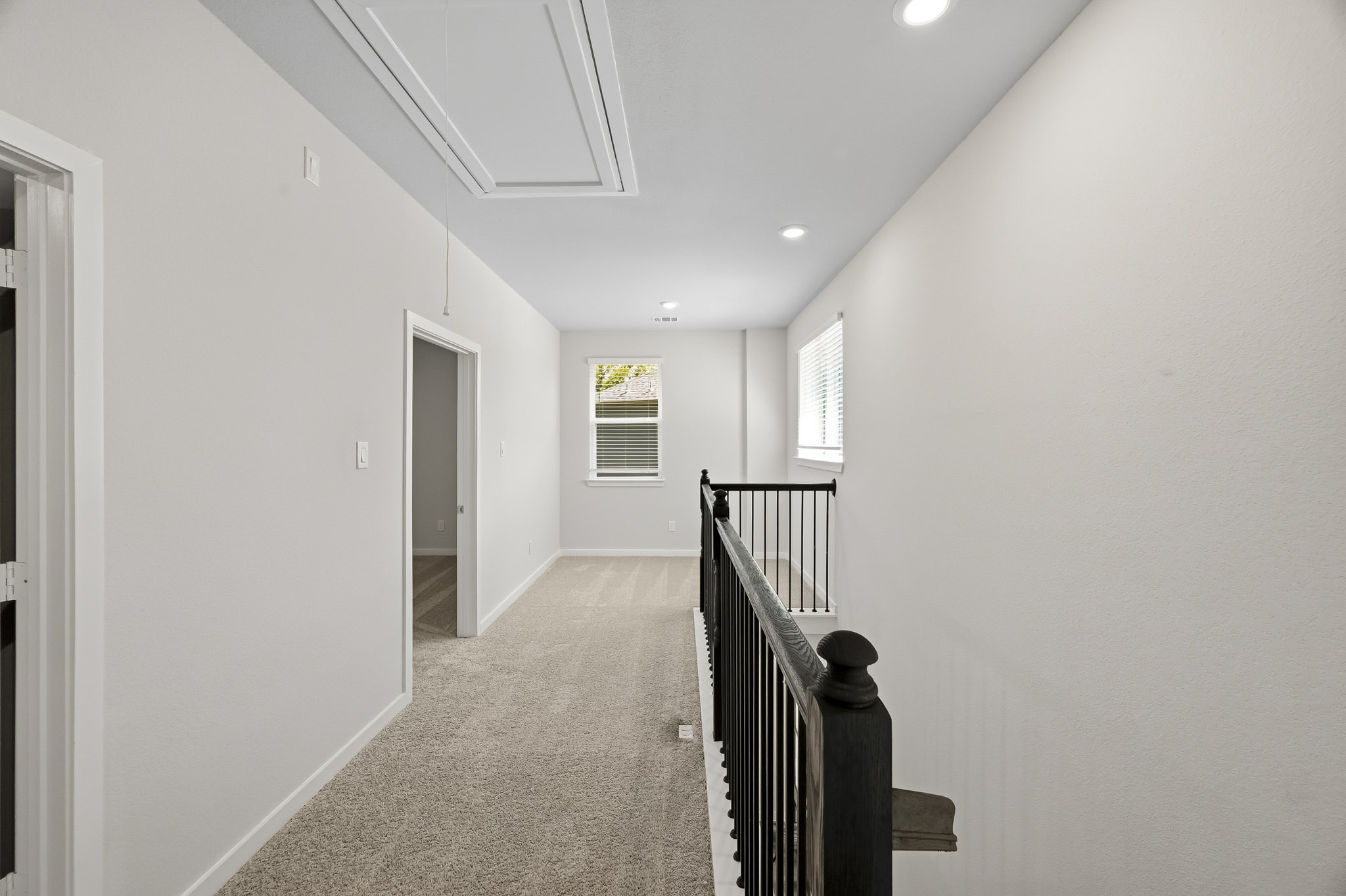 A hallway with a staircase.