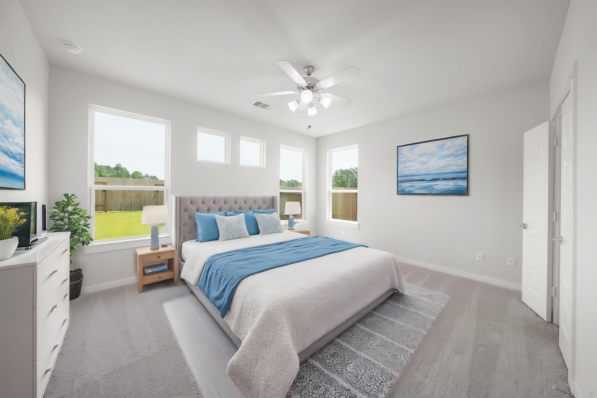 A bedroom with a bed and a fan.