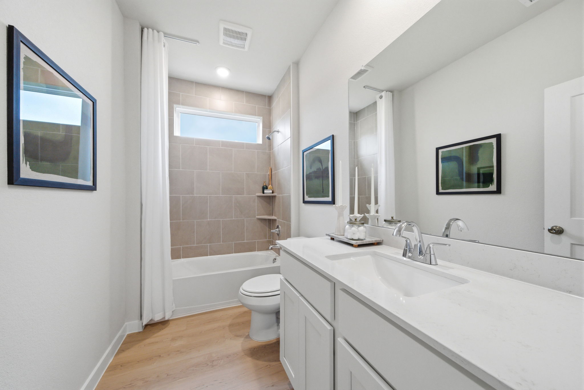 A bathroom with a tub toilet and sink.