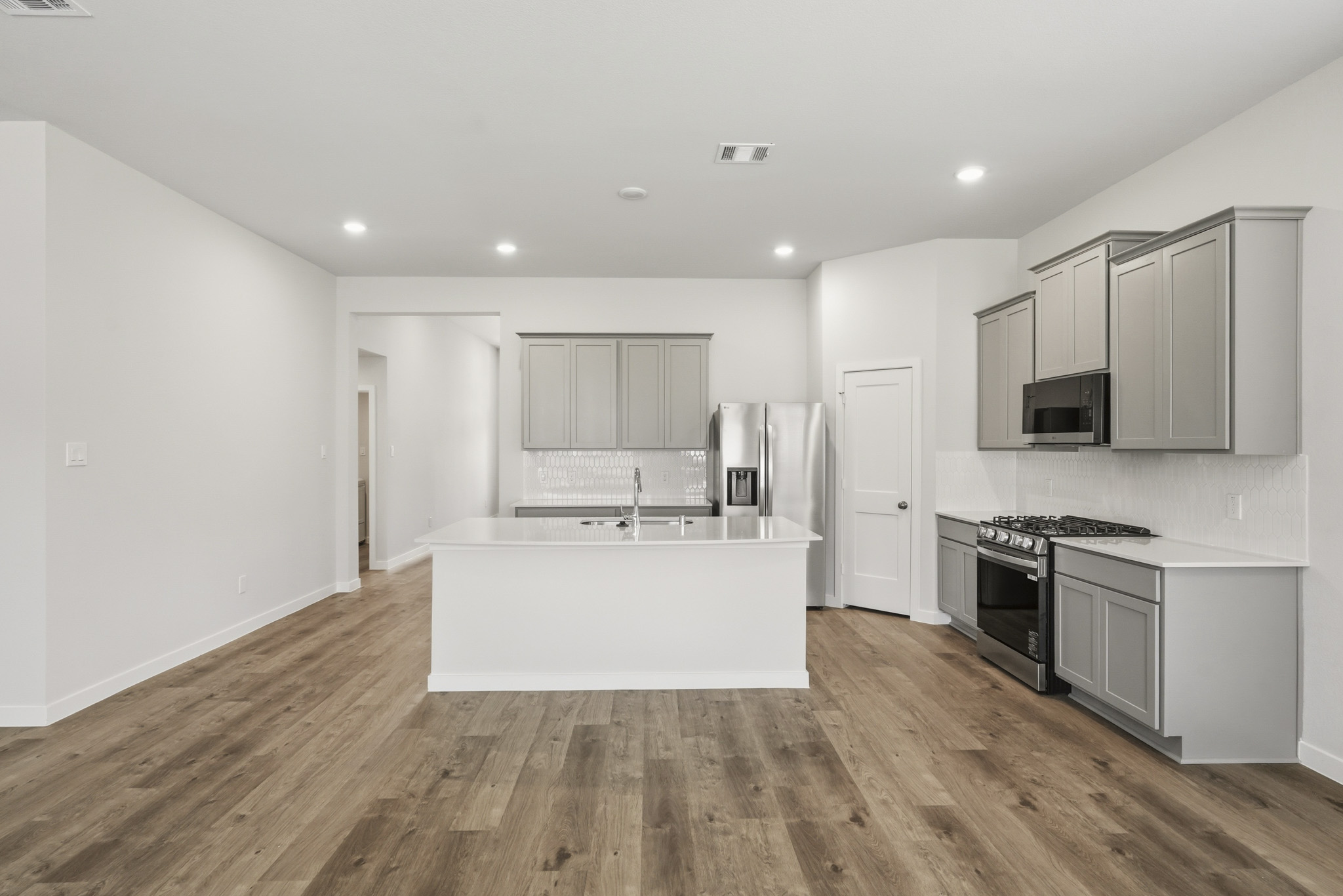 A kitchen with white cabinets.