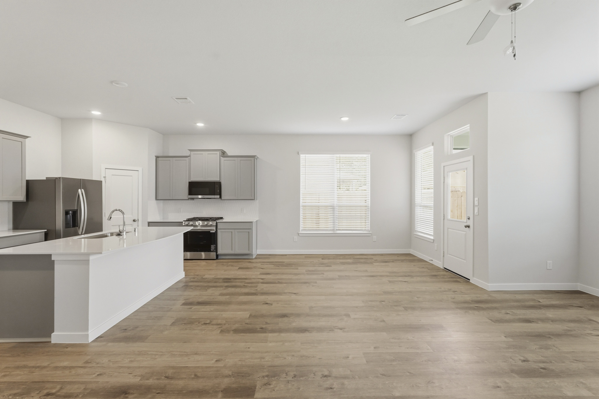 A kitchen with white cabinets.
