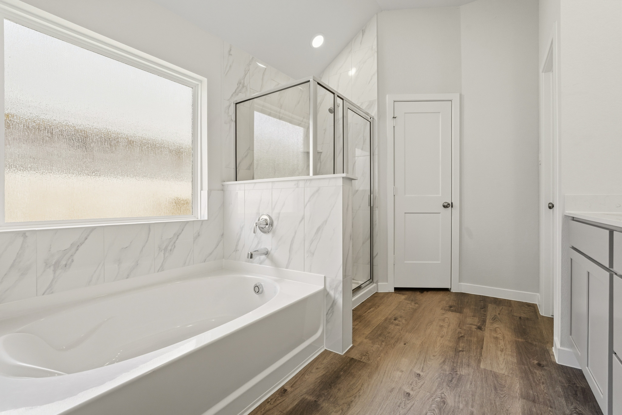 A bathroom with a tub and sink.