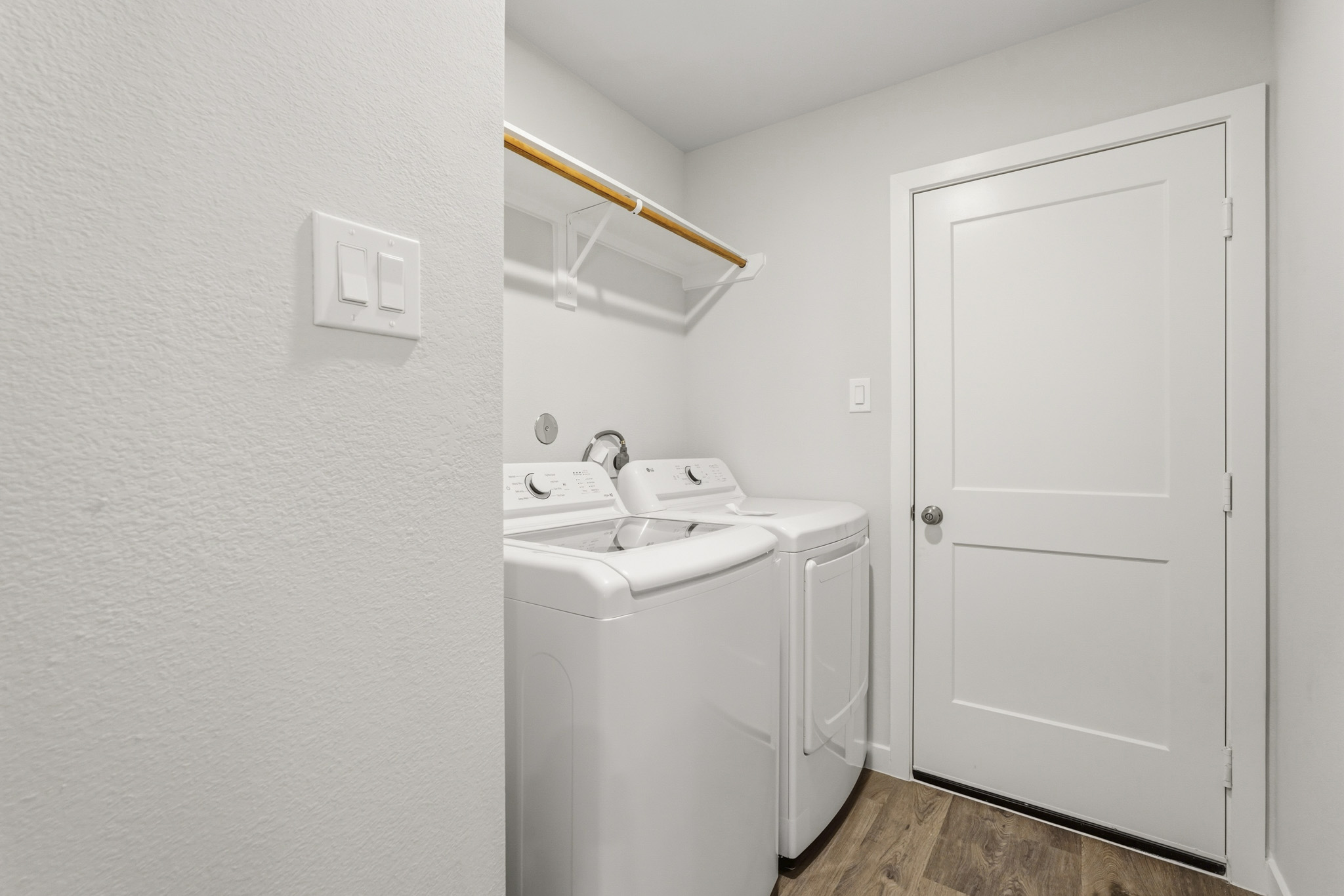 A bathroom with a sink and a washer.